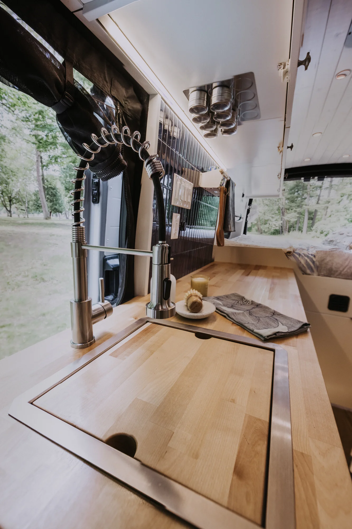 The Drifter 101 custom Ford Transit campervan built for Peter and Linka by Drifter Vans, Scout layout with a coastal interior, light finishes, EcoFlow off-grid power, and a remote work setup