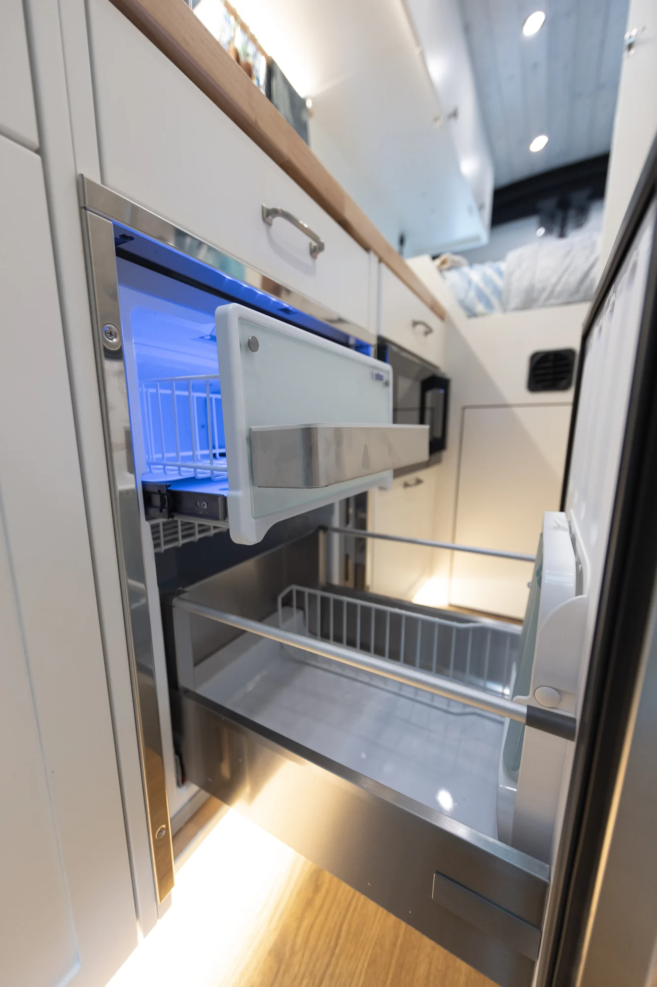 The Drifter 101 custom Ford Transit campervan built for Peter and Linka by Drifter Vans, Scout layout with a coastal interior, light finishes, EcoFlow off-grid power, and a remote work setup
