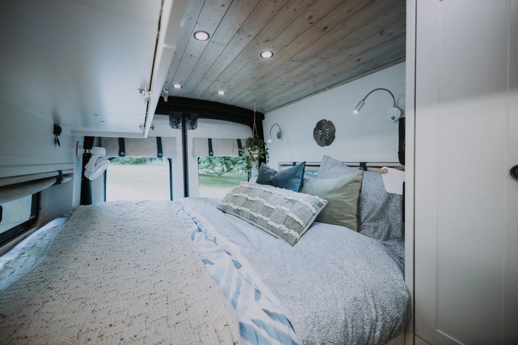 The Drifter 101 custom Ford Transit campervan built for Peter and Linka by Drifter Vans, Scout layout with a coastal interior, light finishes, EcoFlow off-grid power, and a remote work setup