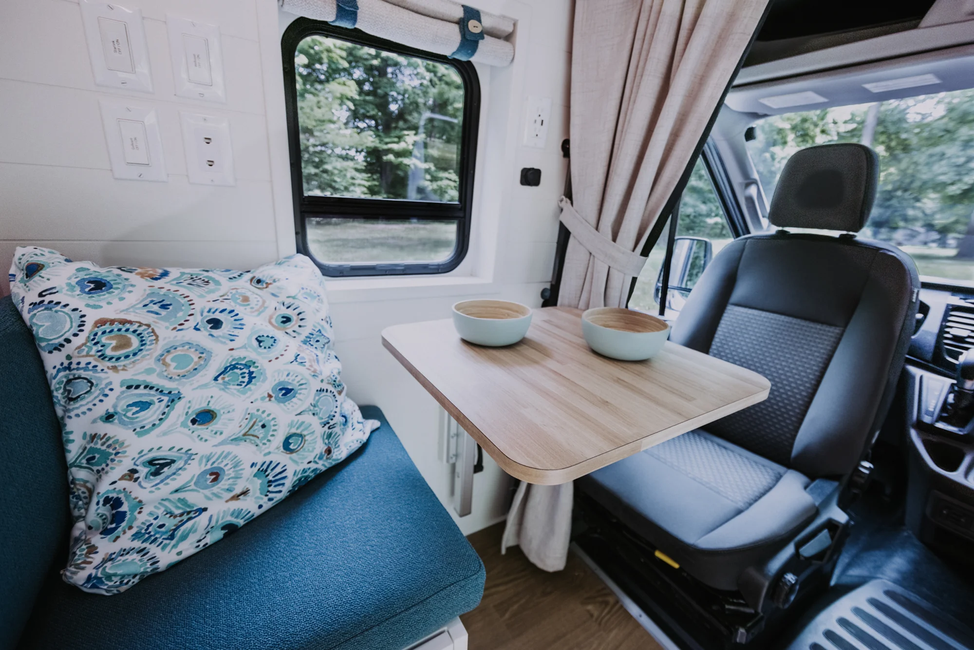 The Drifter 101 custom Ford Transit campervan built for Peter and Linka by Drifter Vans, Scout layout with a coastal interior, light finishes, EcoFlow off-grid power, and a remote work setup