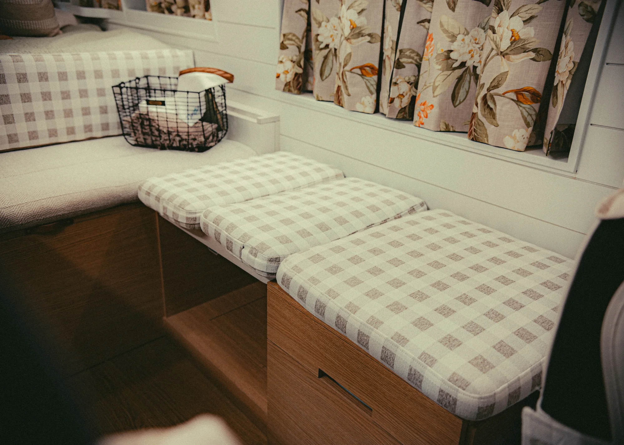 The Drifter 101 custom Ford Transit campervan built for Donna and Stanley by Drifter Vans, farmhouse interior with butcher block countertop, checkered cushions, and floral curtains
