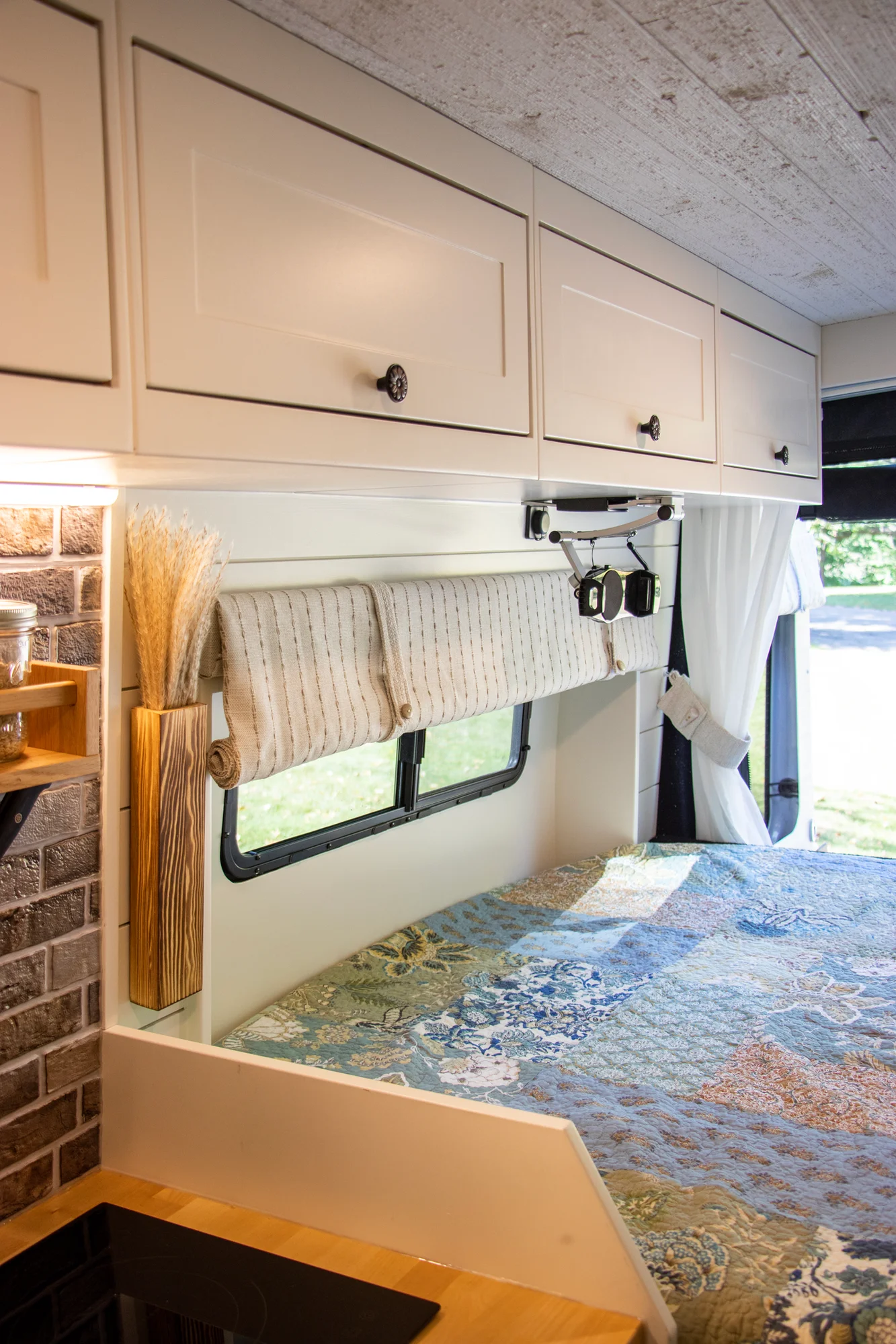 The Drifter 101 custom Ford Transit campervan built for Steph and Jen by Drifter Vans, Wanderer layout with a brick backsplash, sage green cabinetry, and farmhouse lighting