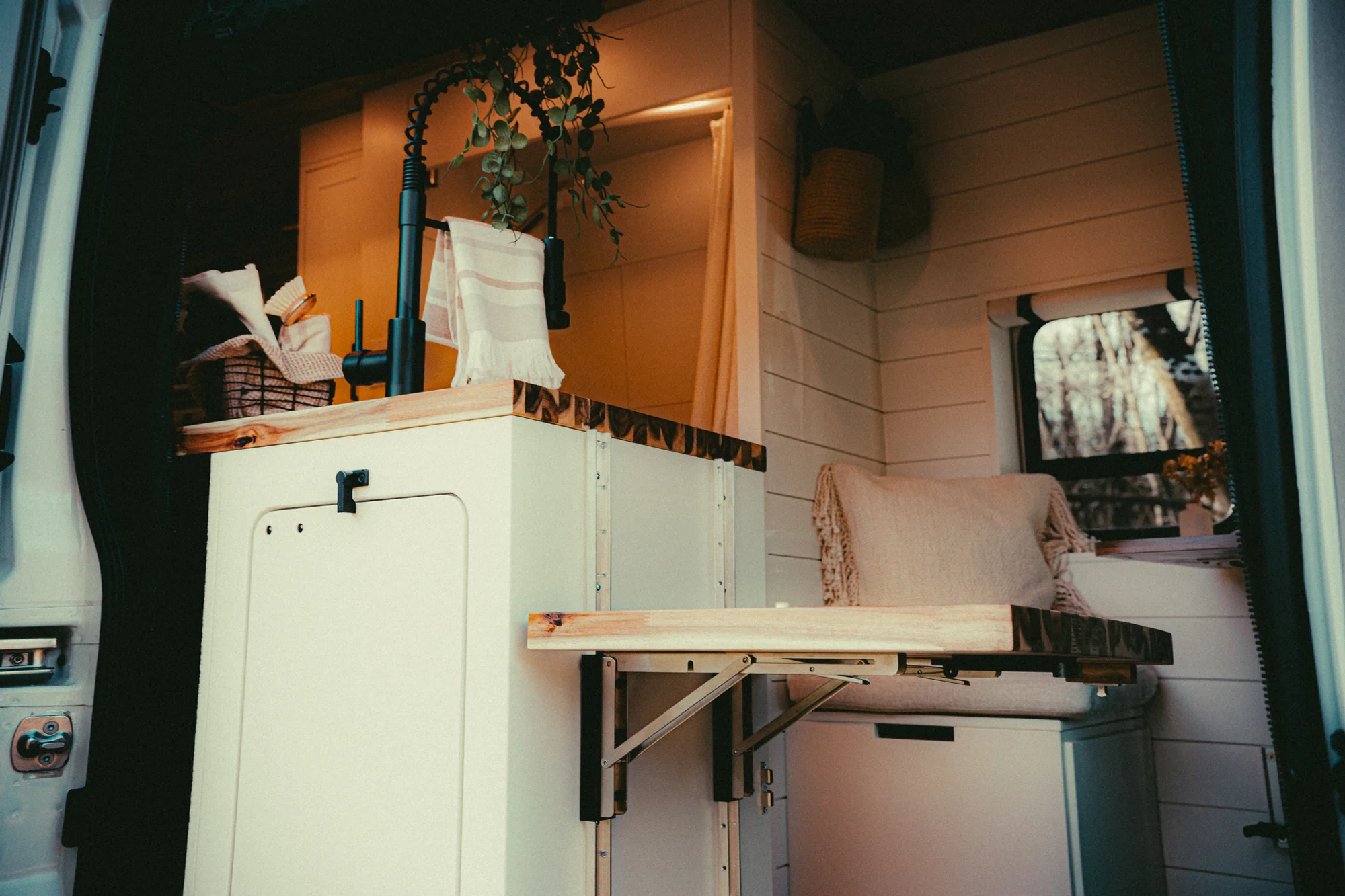 The Drifter 101 custom Ford Transit campervan built for Kyle and Zoe by Drifter Vans, Scout layout with white shiplap walls, light wood cabinetry, and a coastal-inspired interior