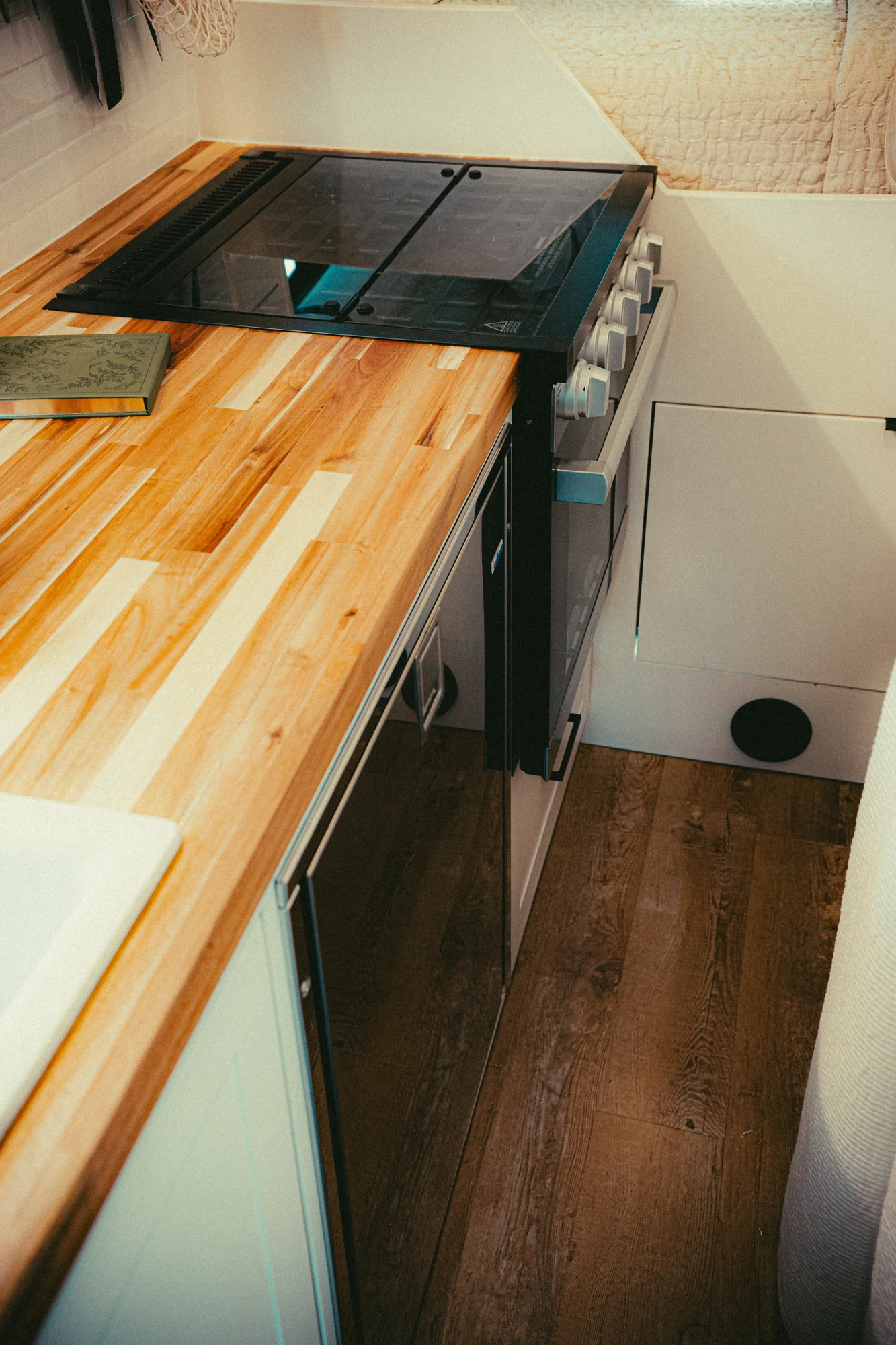 The Drifter 101 custom Ford Transit campervan built for Kyle and Zoe by Drifter Vans, Scout layout with white shiplap walls, light wood cabinetry, and a coastal-inspired interior