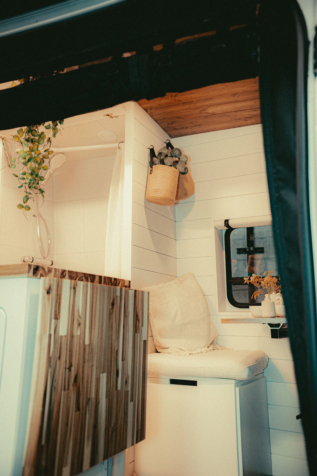 The Drifter 101 custom Ford Transit campervan built for Kyle and Zoe by Drifter Vans, Scout layout with white shiplap walls, light wood cabinetry, and a coastal-inspired interior
