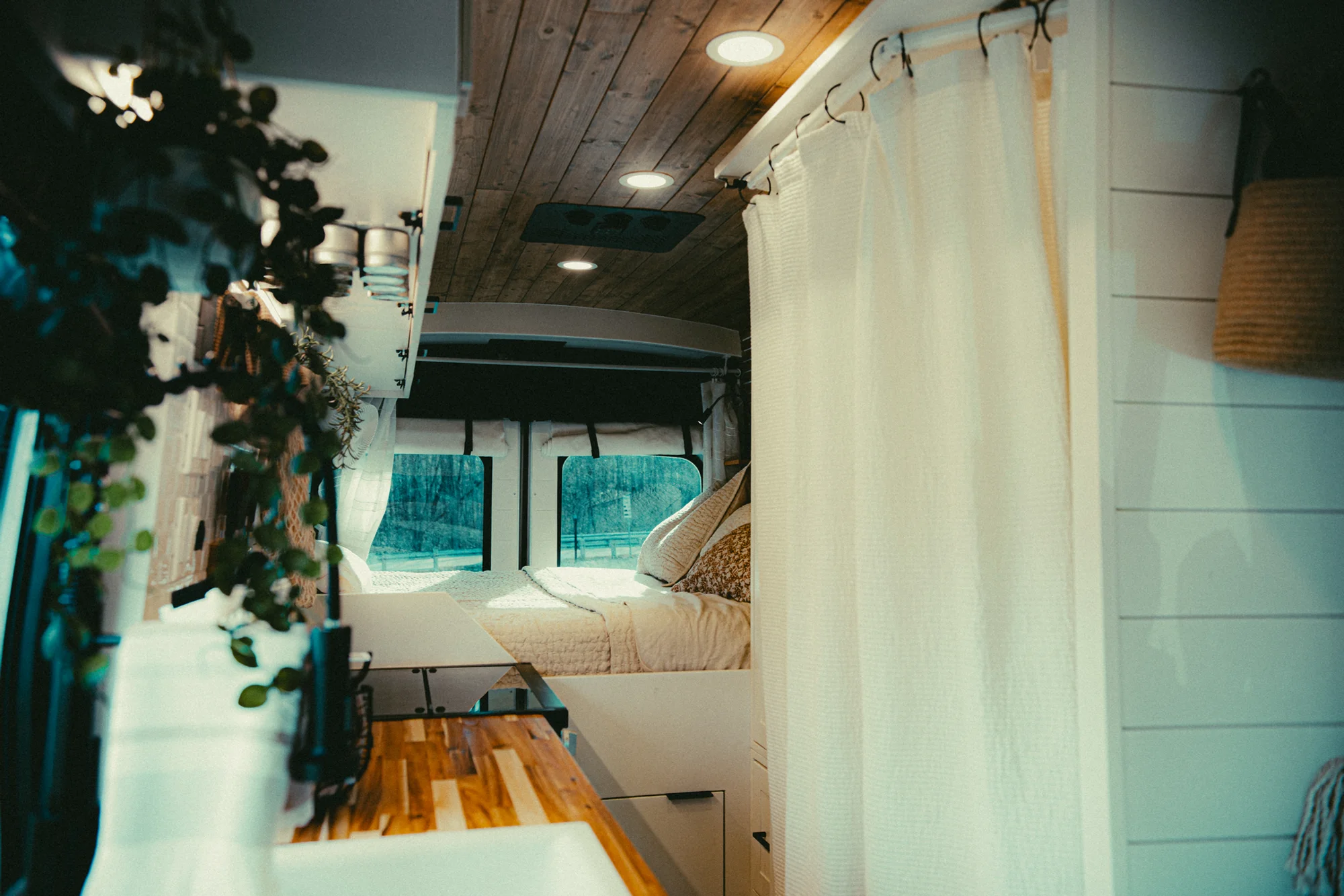 The Drifter 101 custom Ford Transit campervan built for Kyle and Zoe by Drifter Vans, Scout layout with white shiplap walls, light wood cabinetry, and a coastal-inspired interior