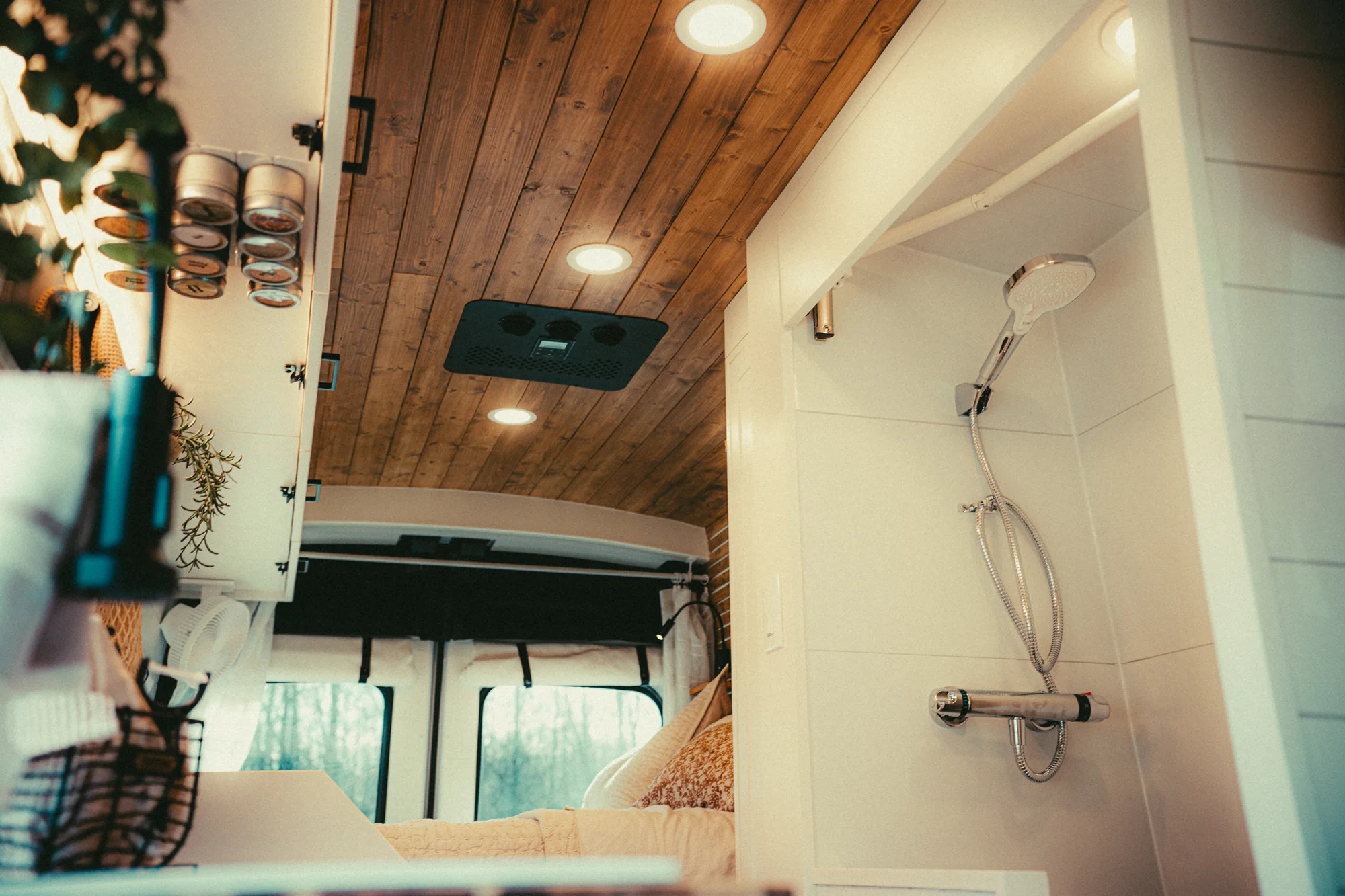 The Drifter 101 custom Ford Transit campervan built for Kyle and Zoe by Drifter Vans, Scout layout with white shiplap walls, light wood cabinetry, and a coastal-inspired interior