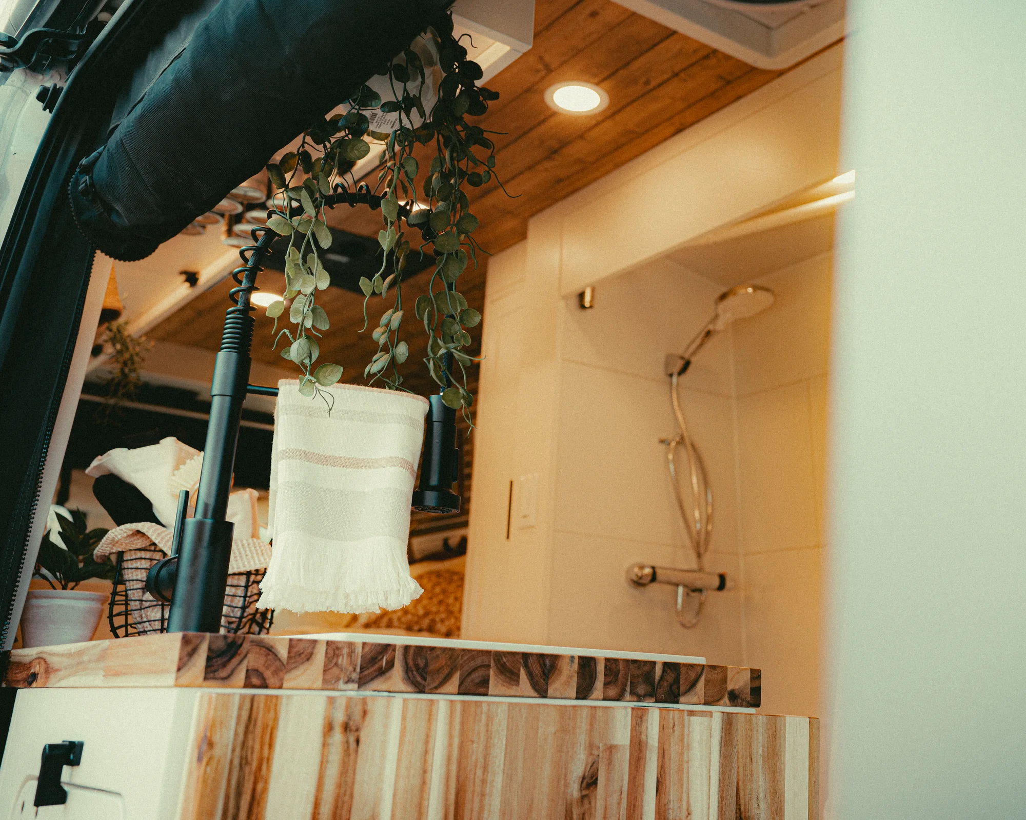 The Drifter 101 custom Ford Transit campervan built for Kyle and Zoe by Drifter Vans, Scout layout with white shiplap walls, light wood cabinetry, and a coastal-inspired interior