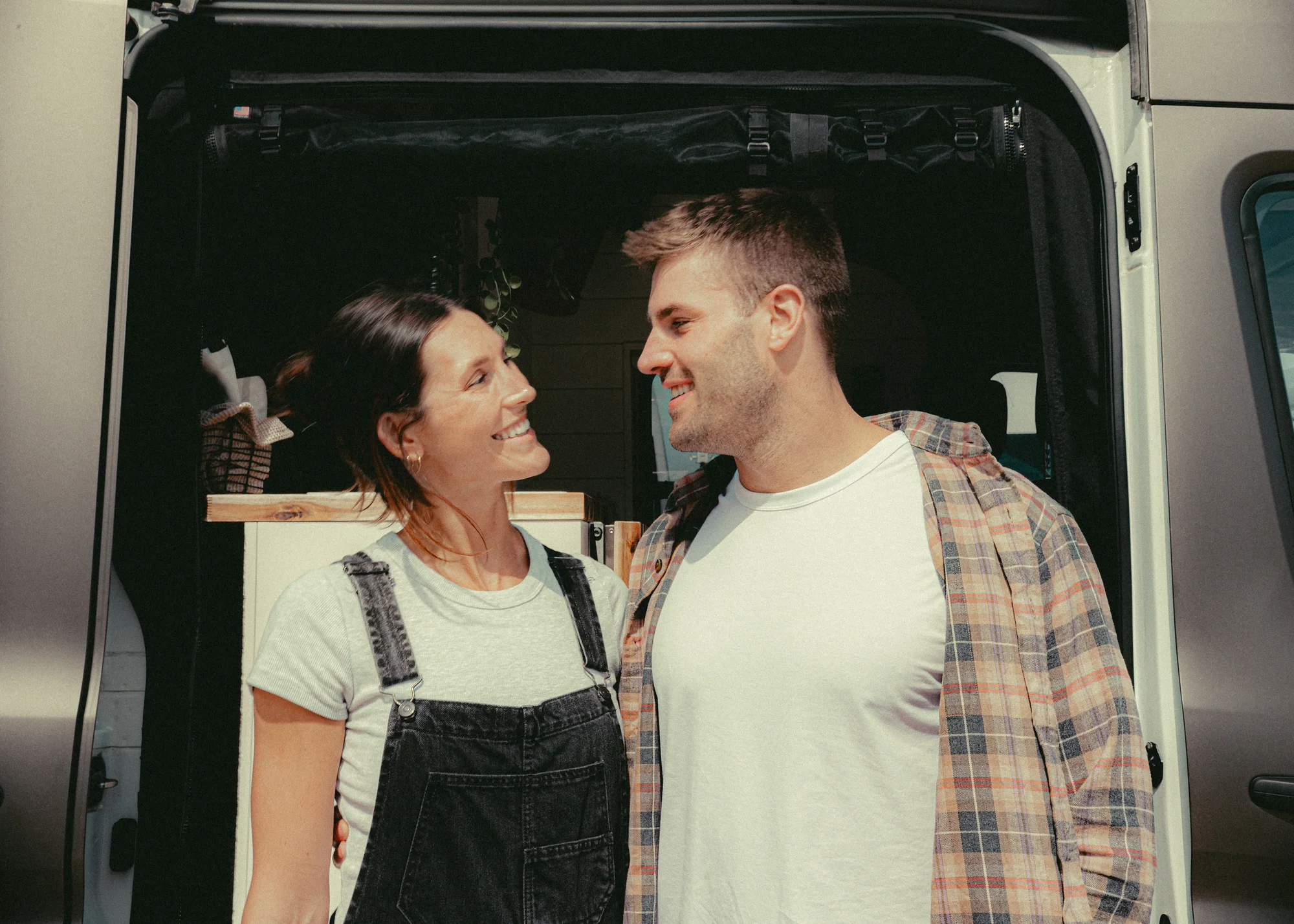 The Drifter 101 custom Ford Transit campervan built for Kyle and Zoe by Drifter Vans, Scout layout with white shiplap walls, light wood cabinetry, and a coastal-inspired interior