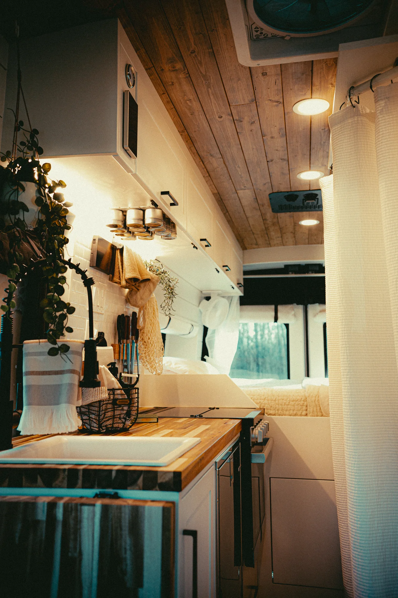 The Drifter 101 custom Ford Transit campervan built for Kyle and Zoe by Drifter Vans, Scout layout with white shiplap walls, light wood cabinetry, and a coastal-inspired interior