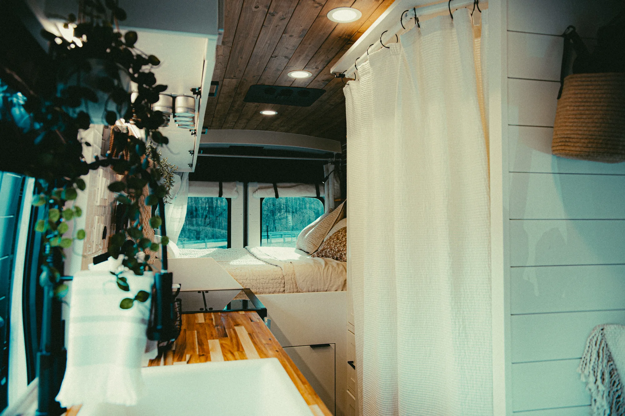 The Drifter 101 custom Ford Transit campervan built for Kyle and Zoe by Drifter Vans, Scout layout with white shiplap walls, light wood cabinetry, and a coastal-inspired interior