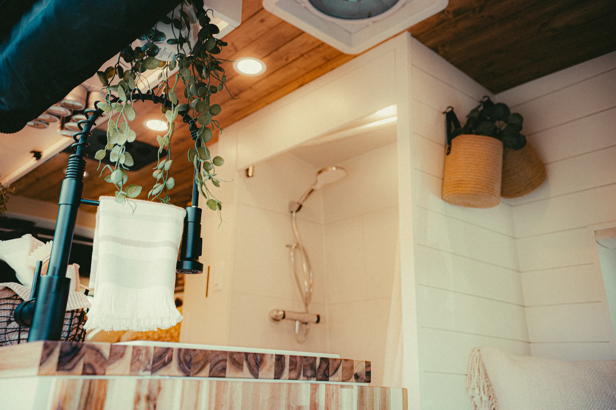 The Drifter 101 custom Ford Transit campervan built for Kyle and Zoe by Drifter Vans, Scout layout with white shiplap walls, light wood cabinetry, and a coastal-inspired interior
