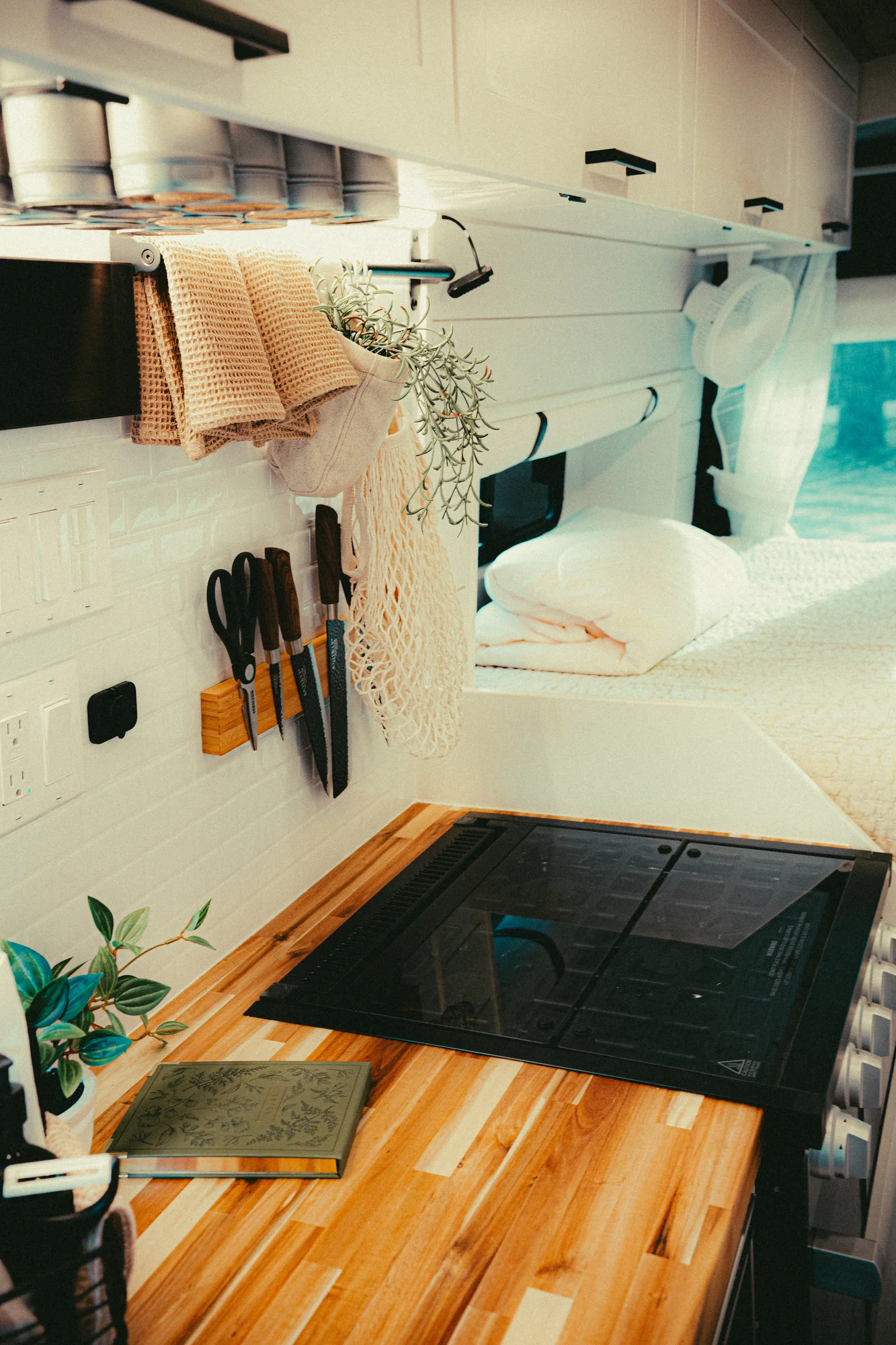The Drifter 101 custom Ford Transit campervan built for Kyle and Zoe by Drifter Vans, Scout layout with white shiplap walls, light wood cabinetry, and a coastal-inspired interior
