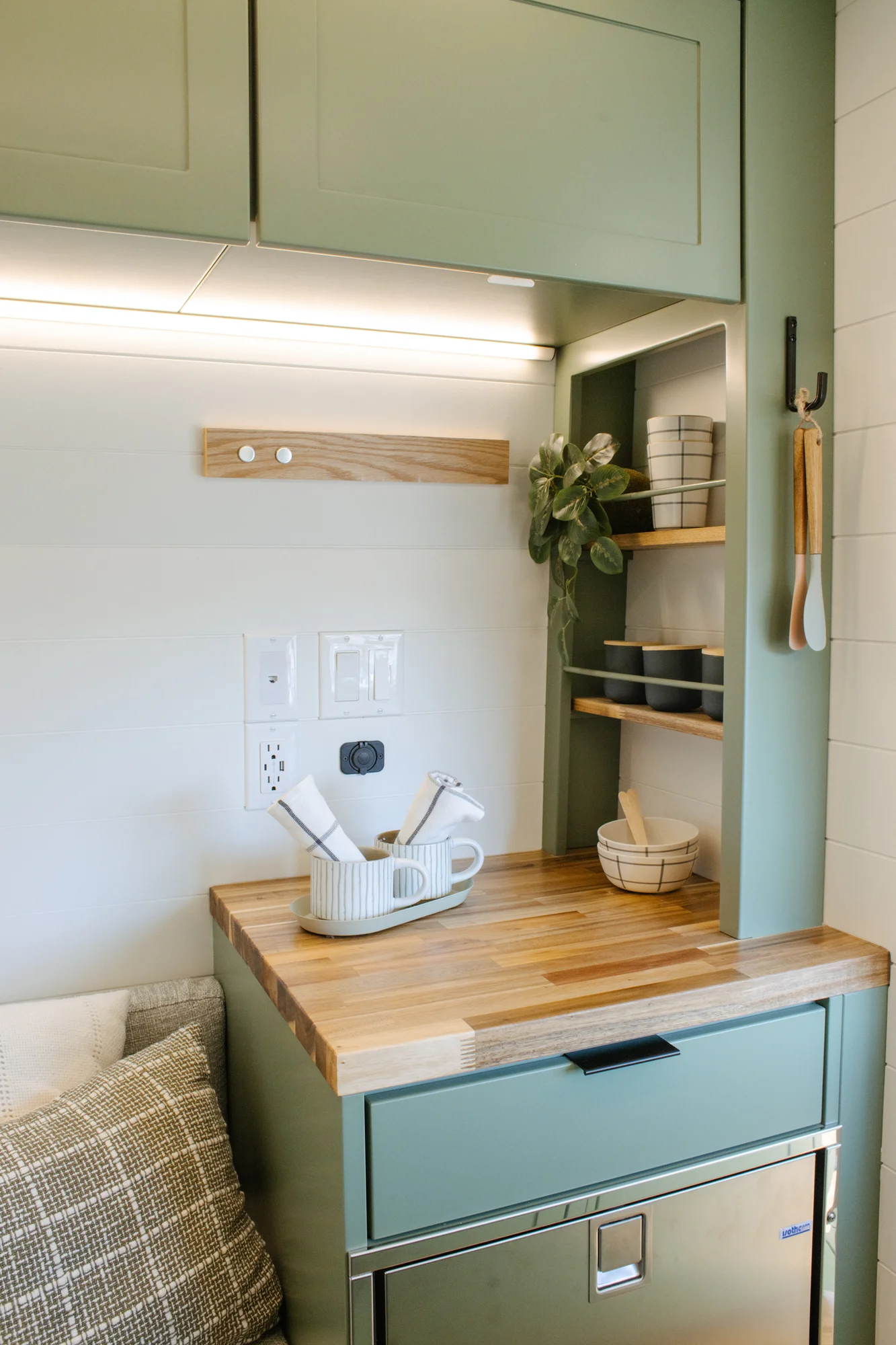 The Drifter 101 custom Ford Transit campervan built for Linda by Drifter Vans, Wanderer layout with sage green cabinetry, floral curtains, and a farmhouse-style interior