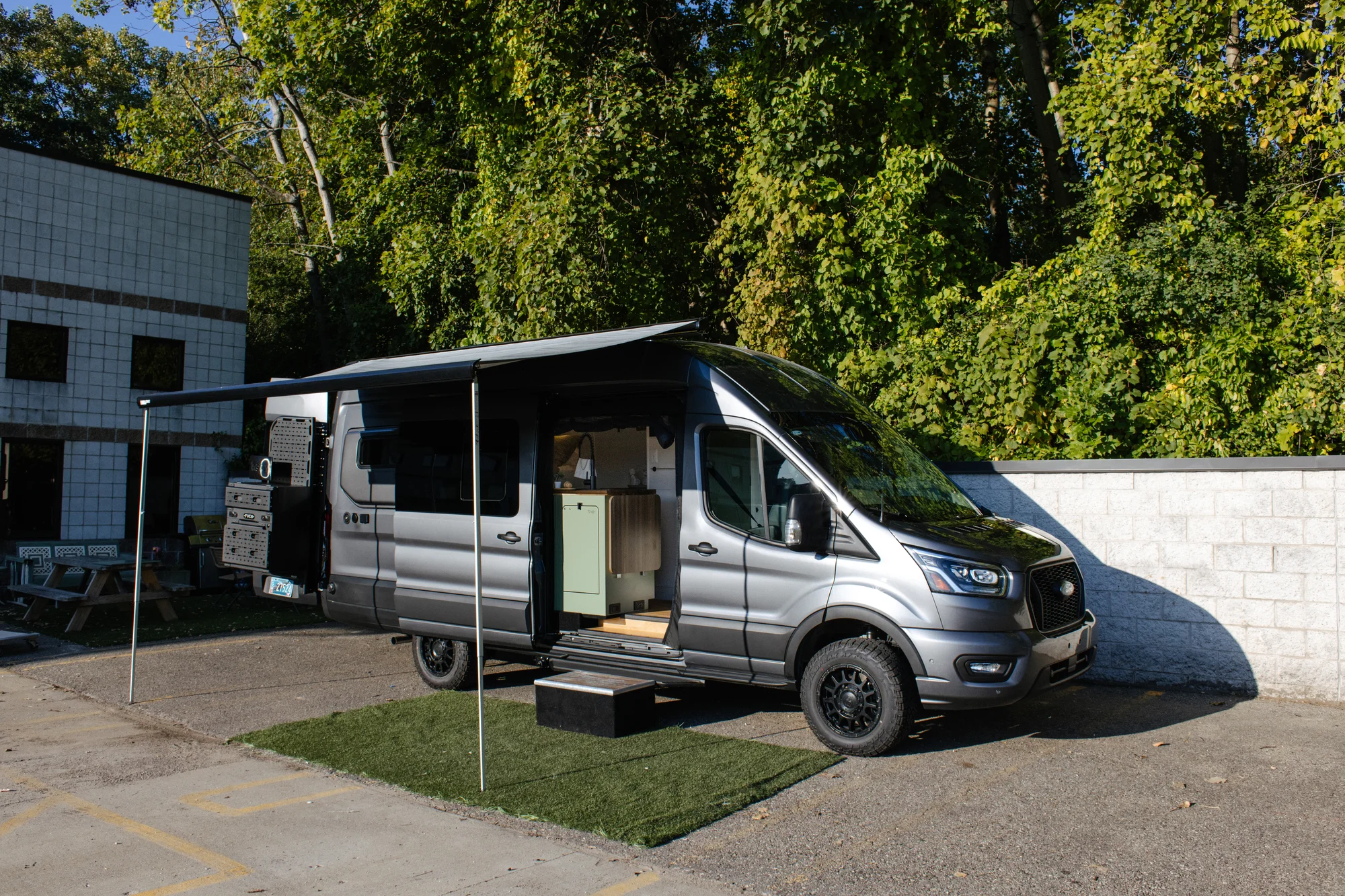The Drifter 101 custom Ford Transit campervan built for Linda by Drifter Vans, Wanderer layout with sage green cabinetry, floral curtains, and a farmhouse-style interior
