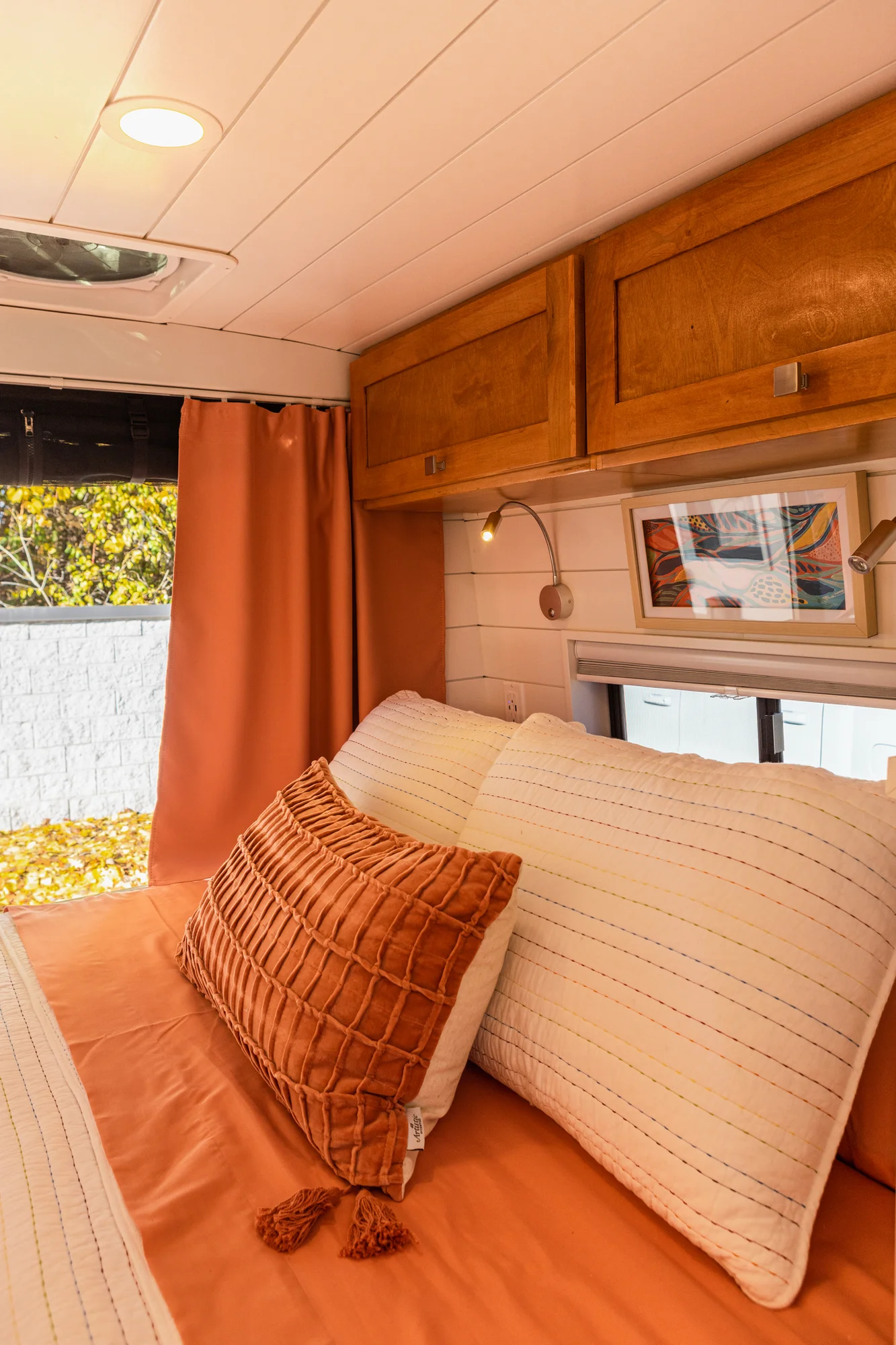 The Drifter 101 custom Ford Transit campervan built for Griff by Drifter Vans, with a bold orange and white interior, herringbone backsplash, and gray tile shower