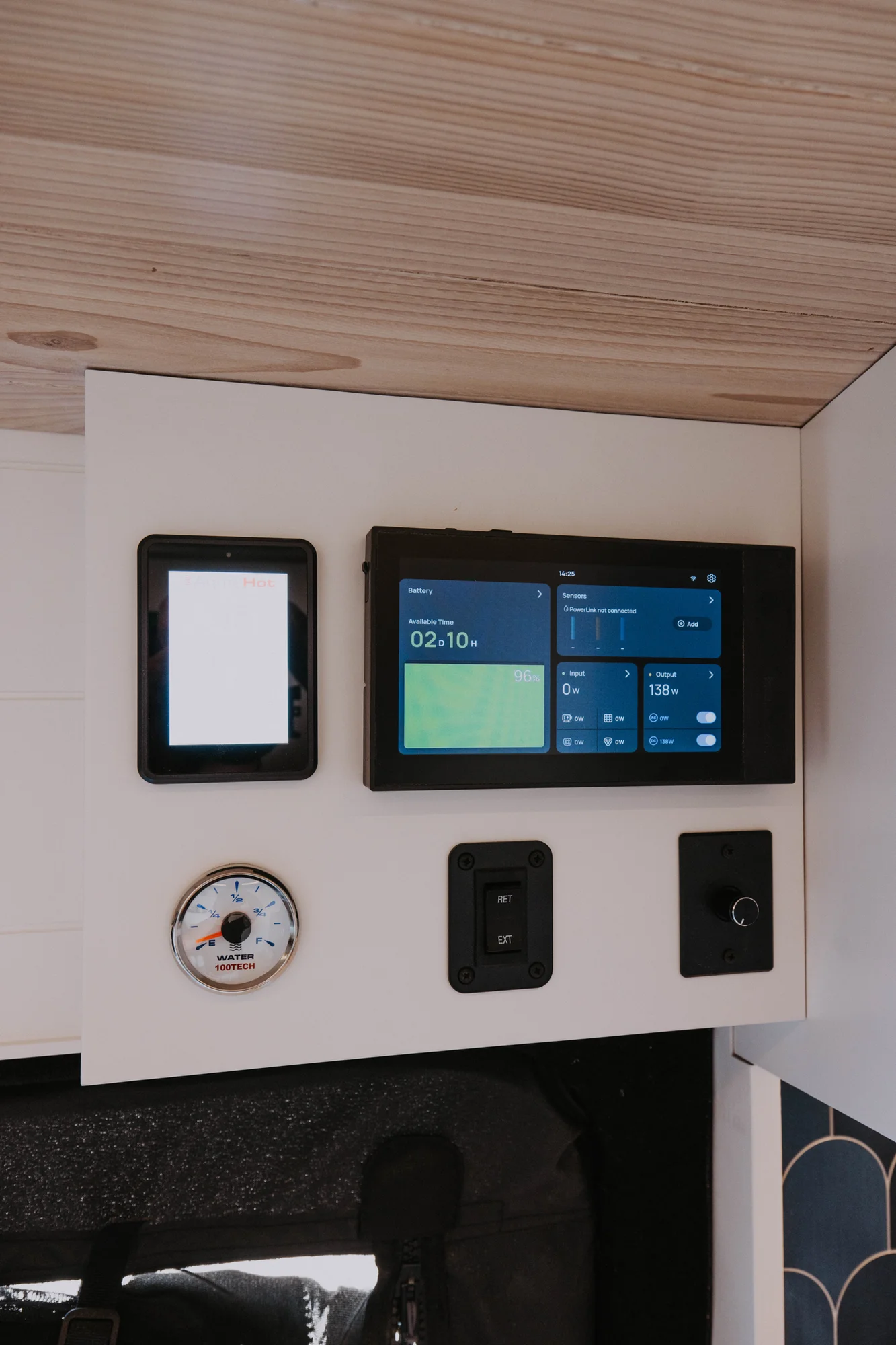 The Drifter 101 custom Ford Transit campervan built for Ayala by Drifter Vans, Drifter layout with warm wood cabinetry, a blue backsplash, flip-down shower, and an Avalanche Grey exterior