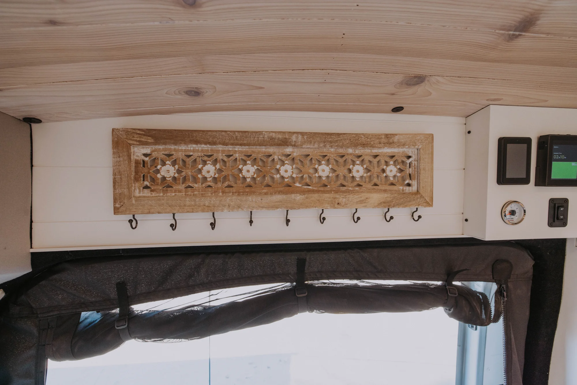 The Drifter 101 custom Ford Transit campervan built for Ayala by Drifter Vans, Drifter layout with warm wood cabinetry, a blue backsplash, flip-down shower, and an Avalanche Grey exterior