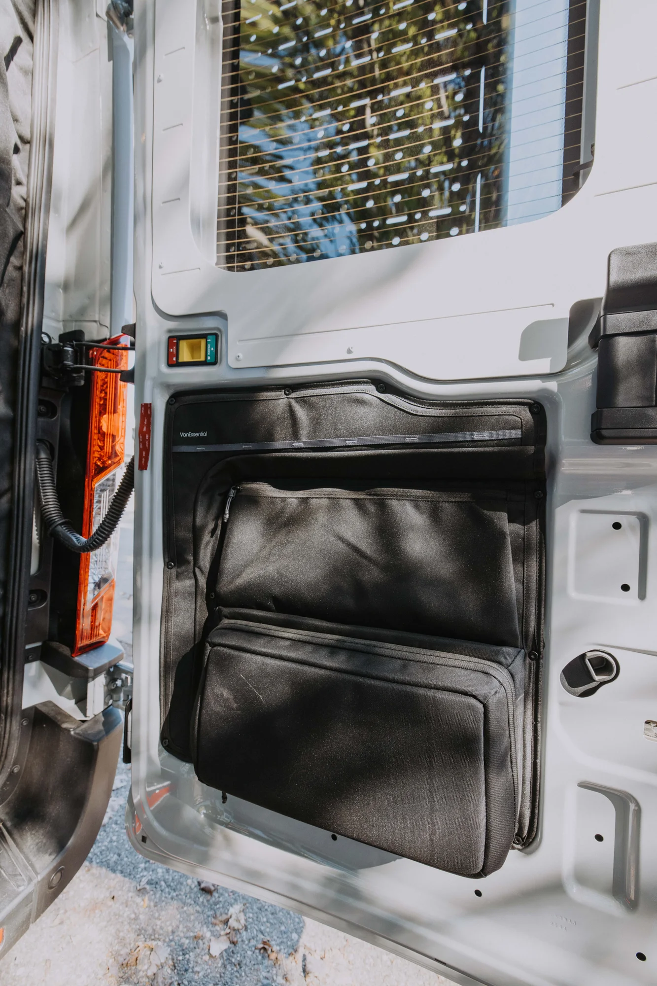 The Drifter 101 custom Ford Transit campervan built for Ayala by Drifter Vans, Drifter layout with warm wood cabinetry, a blue backsplash, flip-down shower, and an Avalanche Grey exterior