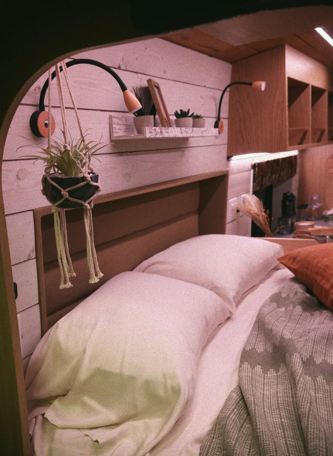 The Drifter 101 custom Ford Transit campervan built for Gardner by Drifter Vans, with warm wood paneling, earthy tones, soft seating, and modular storage