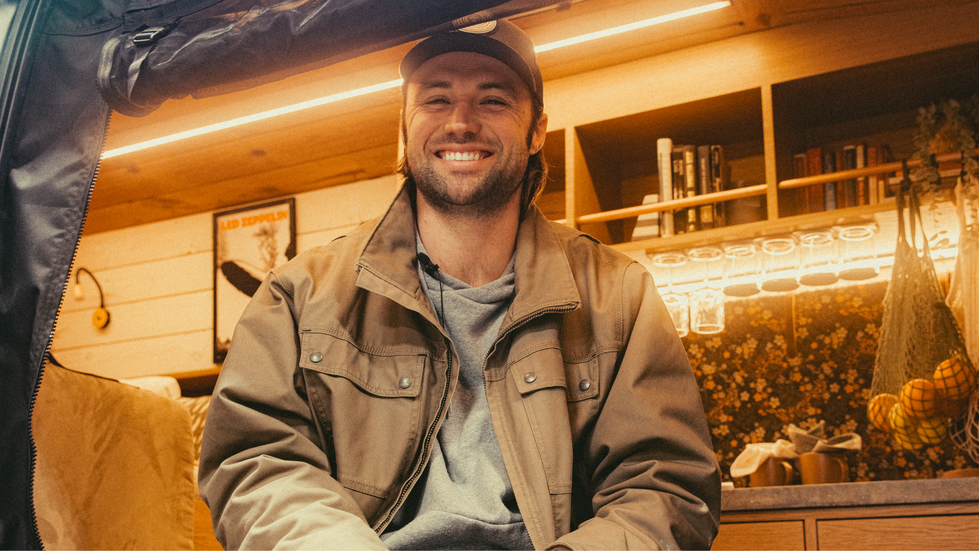 The Drifter 101 custom Ford Transit campervan built for Gardner by Drifter Vans, with warm wood paneling, earthy tones, soft seating, and modular storage