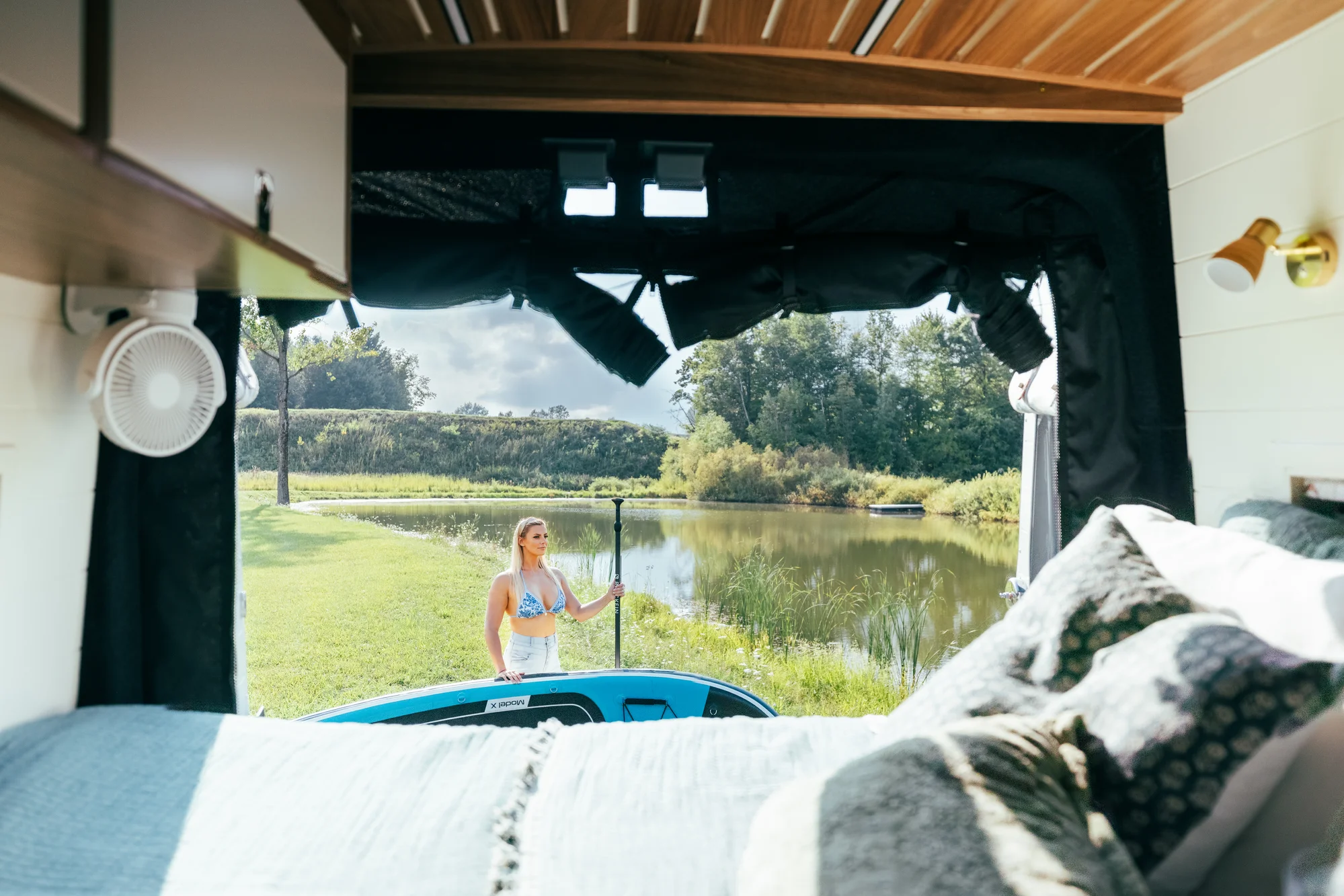 The Drifter 101 custom Ford Transit campervan built for Susan by Drifter Vans, Wanderer layout with modern nautical styling, mother of pearl tile, walnut cabinetry, and blue and white accents