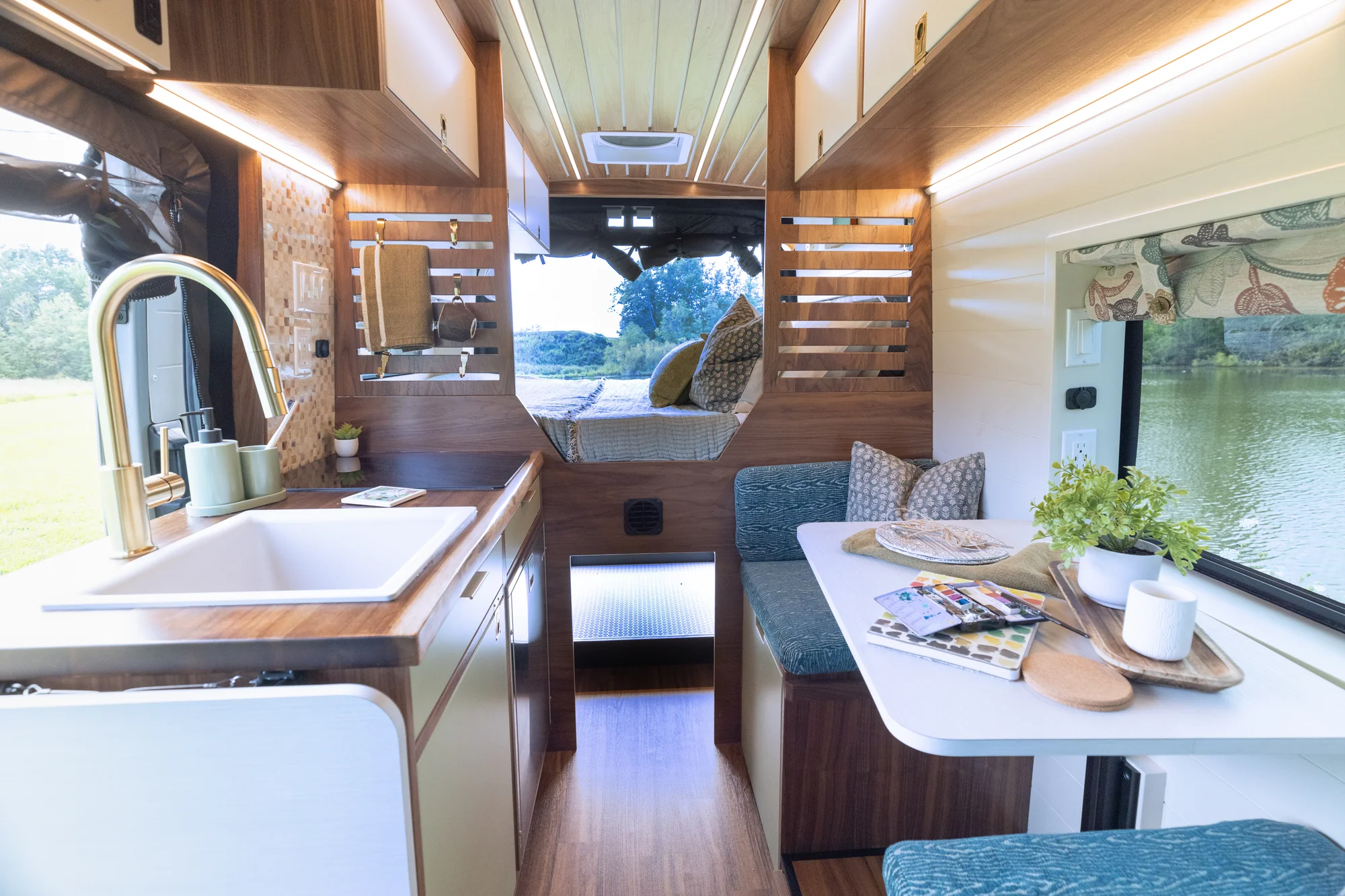 The Drifter 101 custom Ford Transit campervan built for Susan by Drifter Vans, Wanderer layout with modern nautical styling, mother of pearl tile, walnut cabinetry, and blue and white accents