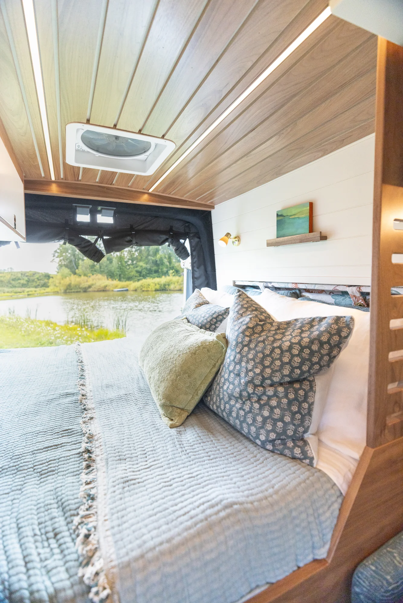 The Drifter 101 custom Ford Transit campervan built for Susan by Drifter Vans, Wanderer layout with modern nautical styling, mother of pearl tile, walnut cabinetry, and blue and white accents