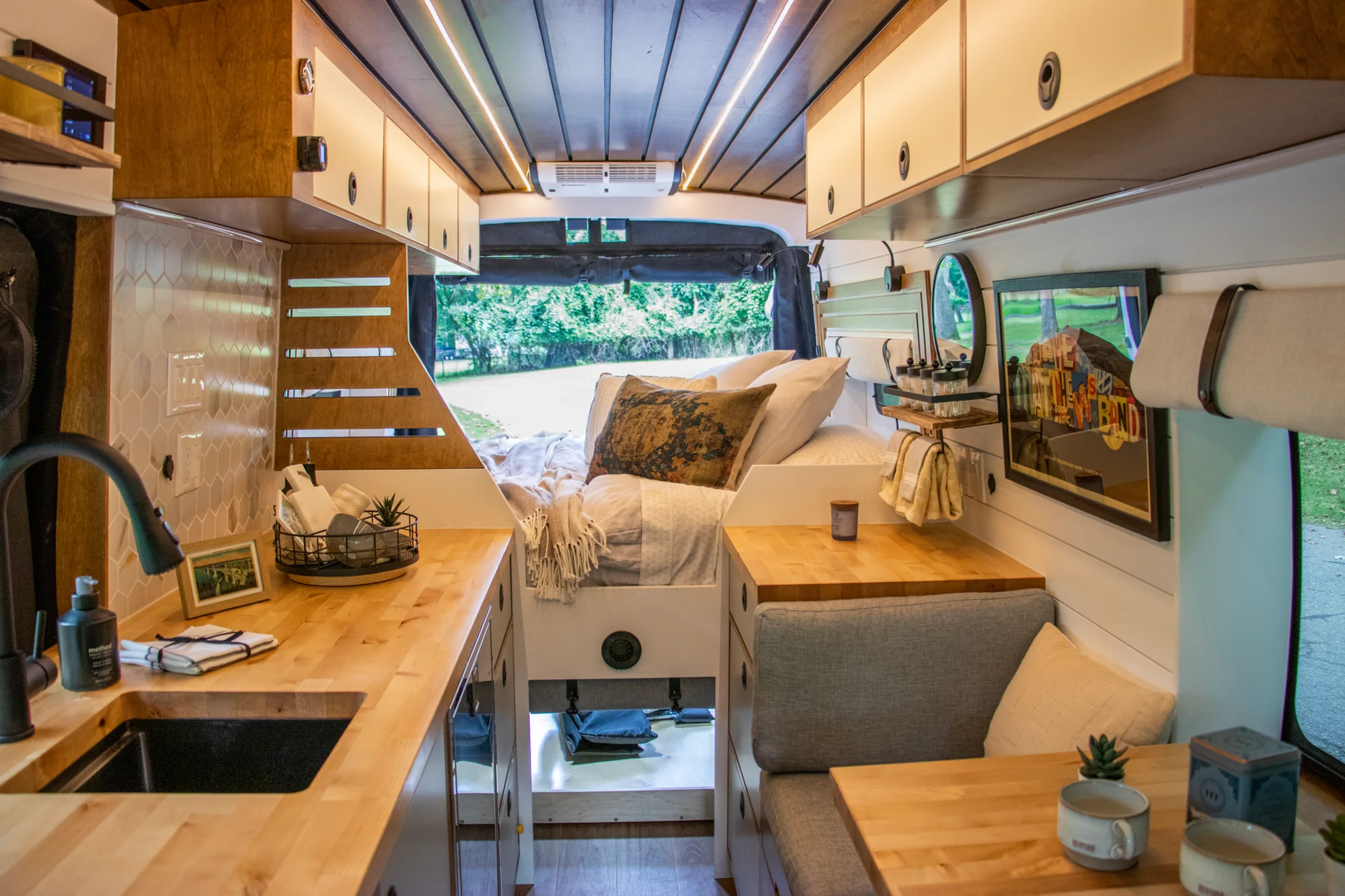 The Drifter 101 custom Ford Transit campervan built for Terry and Michelle by Drifter Vans, Drifter layout with a modern farmhouse interior, gold hardware accents, Tetra shower, and Lagun table