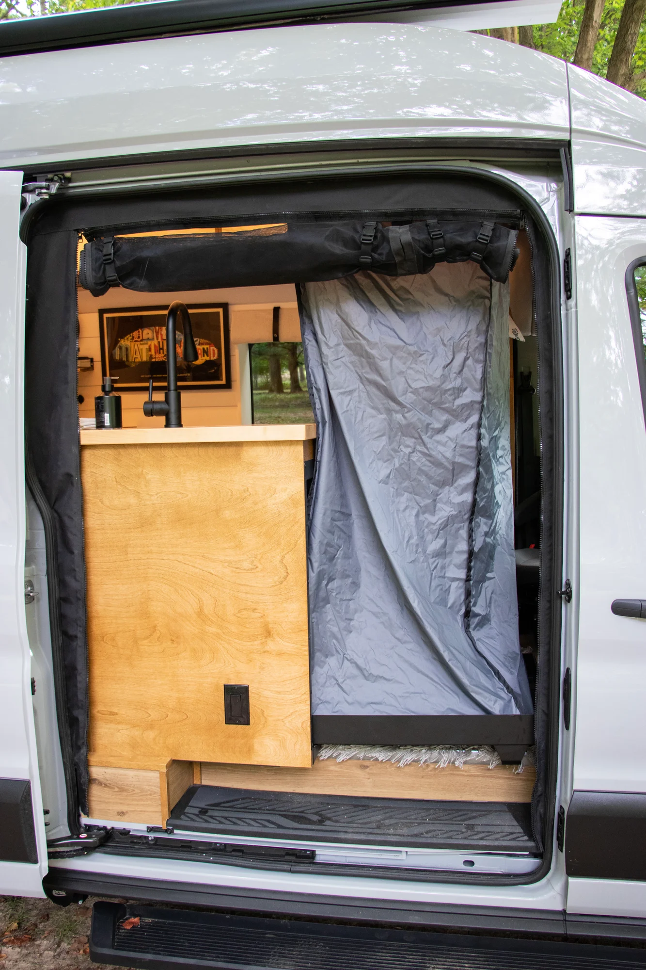 The Drifter 101 custom Ford Transit campervan built for Terry and Michelle by Drifter Vans, Drifter layout with a modern farmhouse interior, gold hardware accents, Tetra shower, and Lagun table