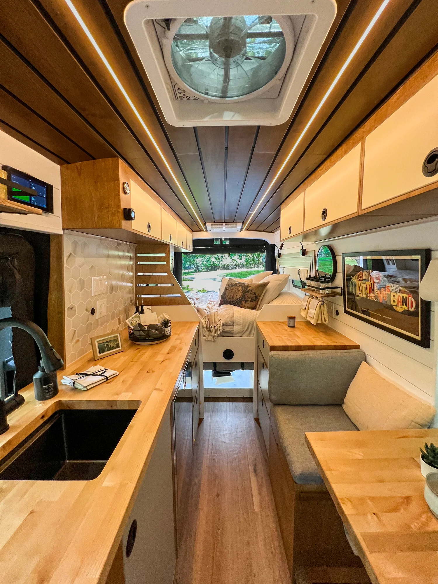 The Drifter 101 custom Ford Transit campervan built for Terry and Michelle by Drifter Vans, Drifter layout with a modern farmhouse interior, gold hardware accents, Tetra shower, and Lagun table