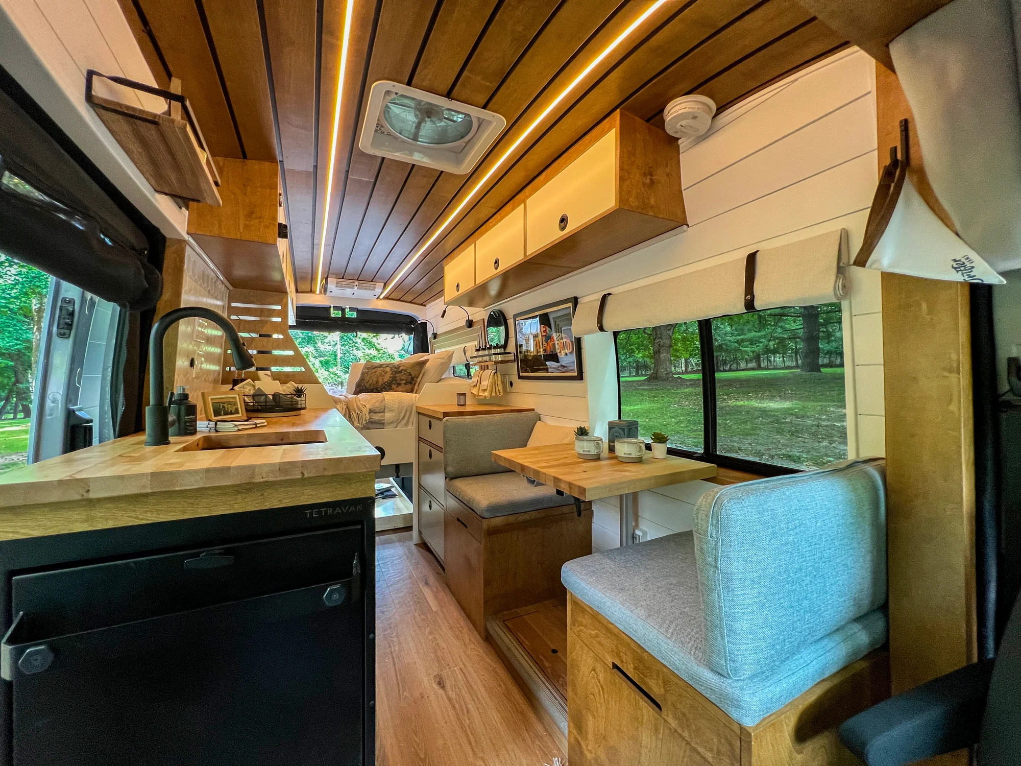 The Drifter 101 custom Ford Transit campervan built for Terry and Michelle by Drifter Vans, Drifter layout with a modern farmhouse interior, gold hardware accents, Tetra shower, and Lagun table