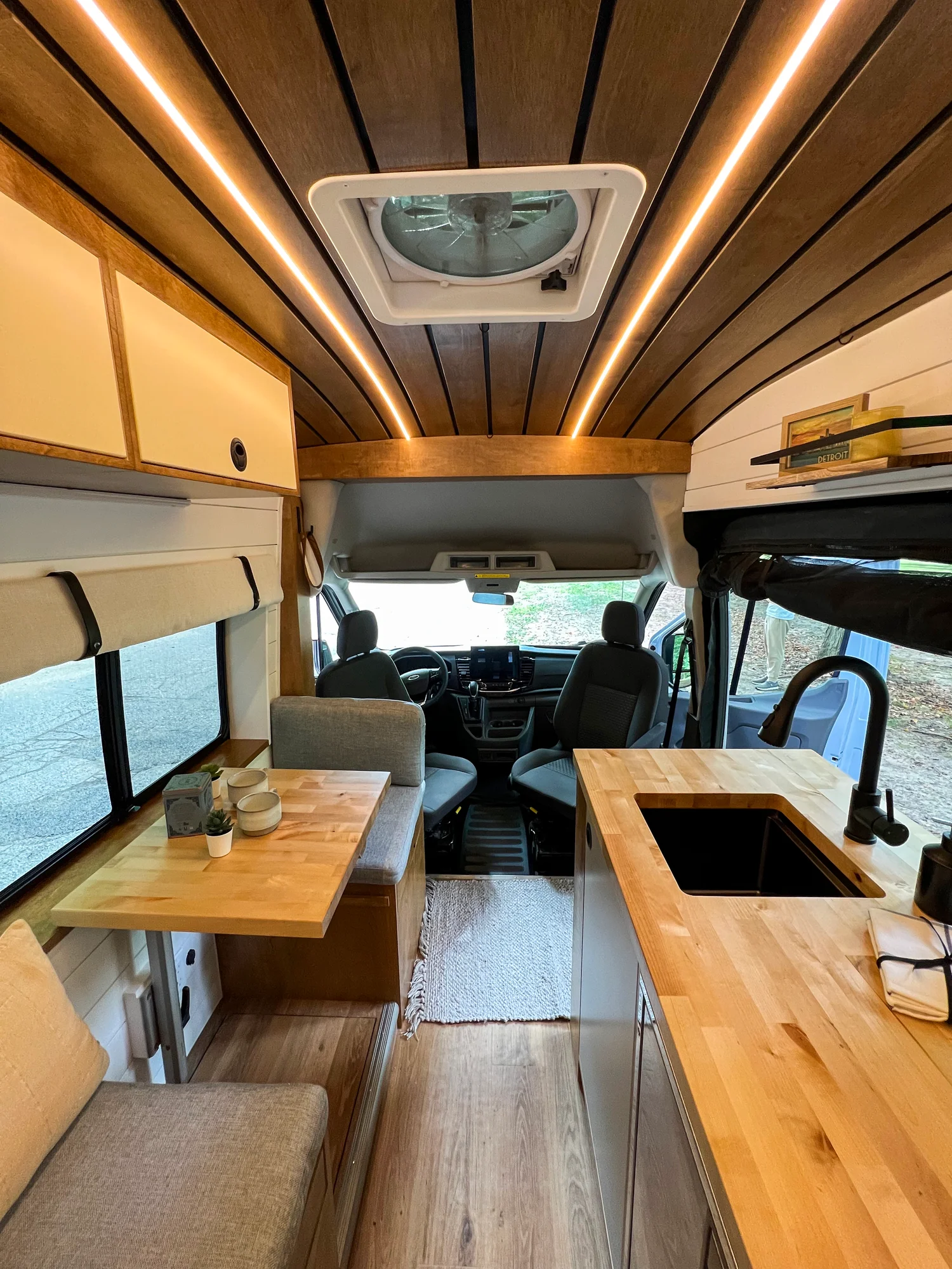 The Drifter 101 custom Ford Transit campervan built for Terry and Michelle by Drifter Vans, Drifter layout with a modern farmhouse interior, gold hardware accents, Tetra shower, and Lagun table