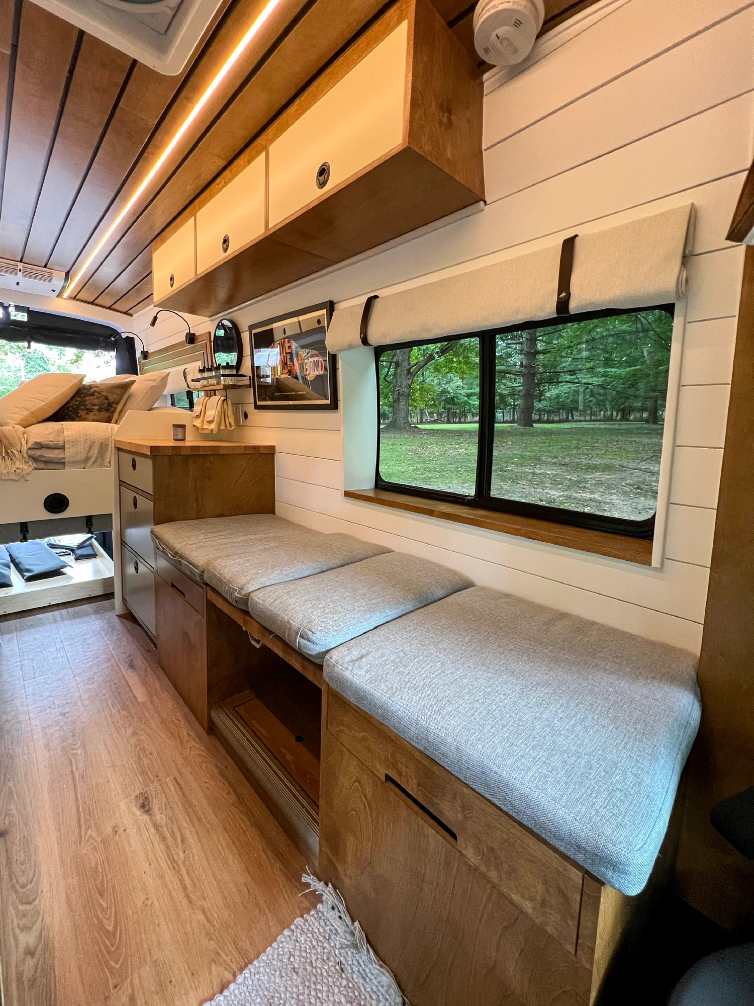 The Drifter 101 custom Ford Transit campervan built for Terry and Michelle by Drifter Vans, Drifter layout with a modern farmhouse interior, gold hardware accents, Tetra shower, and Lagun table
