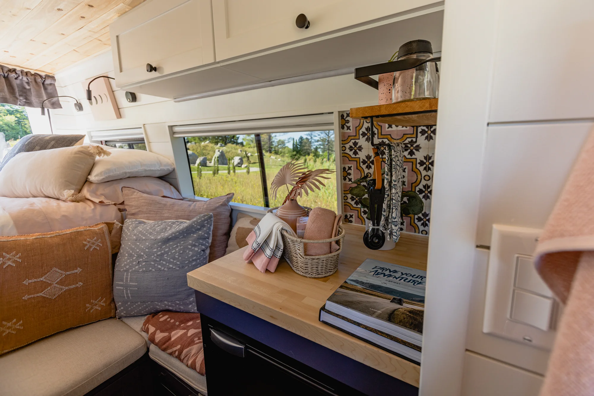 The Drifter 101 custom Mercedes-Benz Sprinter campervan built for Katie by Drifter Vans, with a pink boho interior, butcher block countertop, natural textures, and a full shower