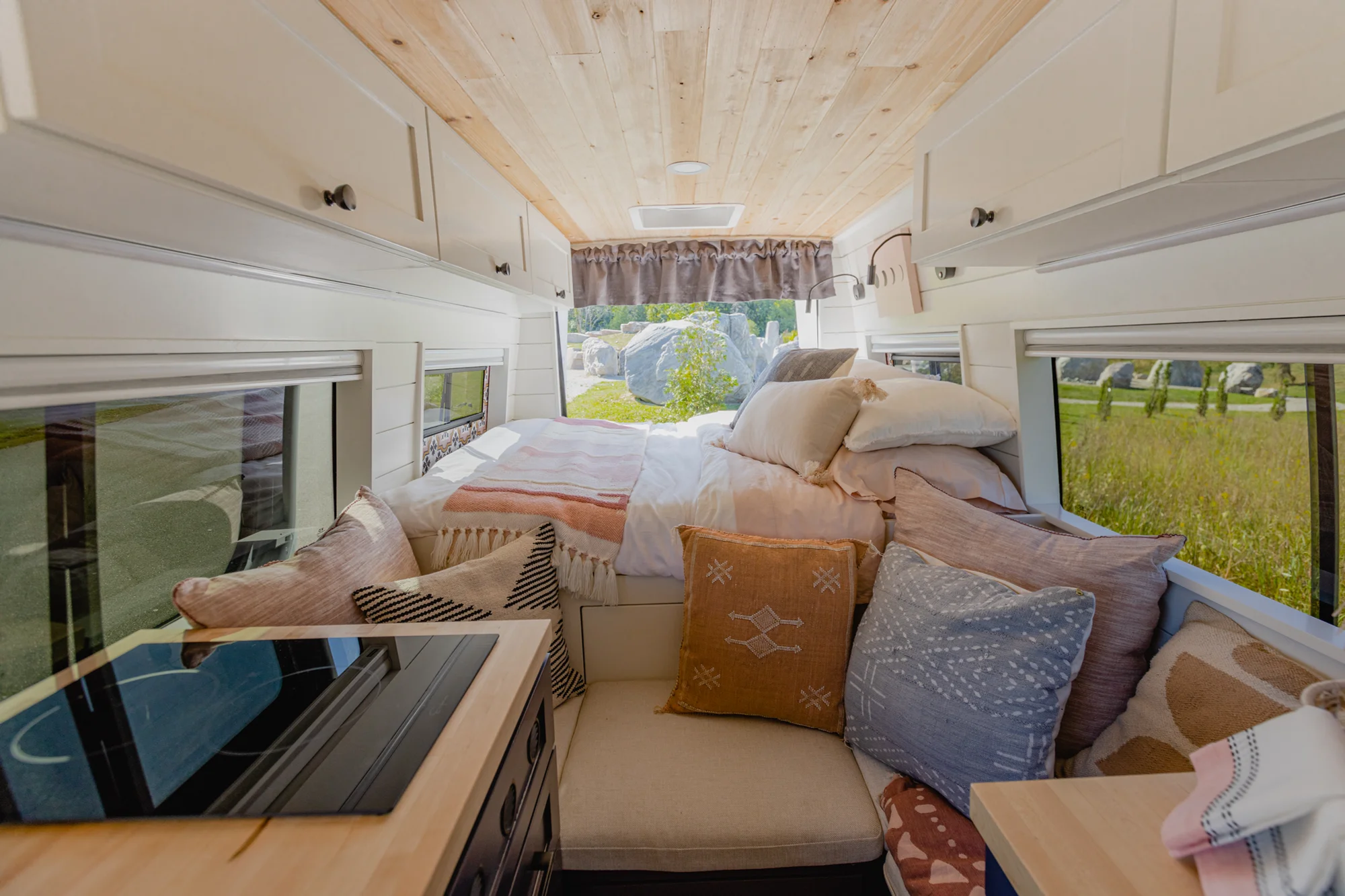 The Drifter 101 custom Mercedes-Benz Sprinter campervan built for Katie by Drifter Vans, with a pink boho interior, butcher block countertop, natural textures, and a full shower