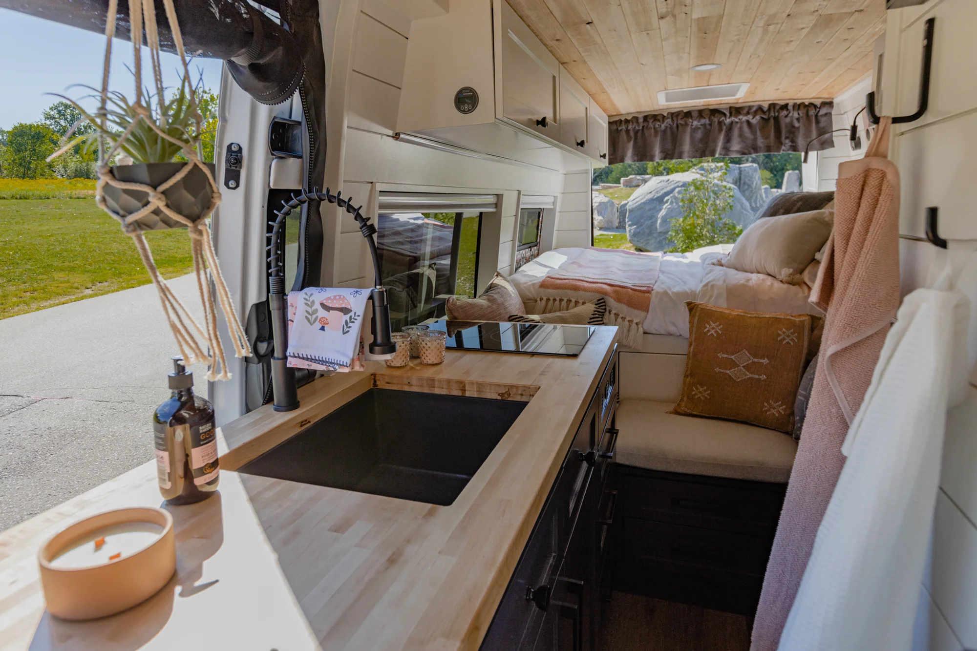 The Drifter 101 custom Mercedes-Benz Sprinter campervan built for Katie by Drifter Vans, with a pink boho interior, butcher block countertop, natural textures, and a full shower