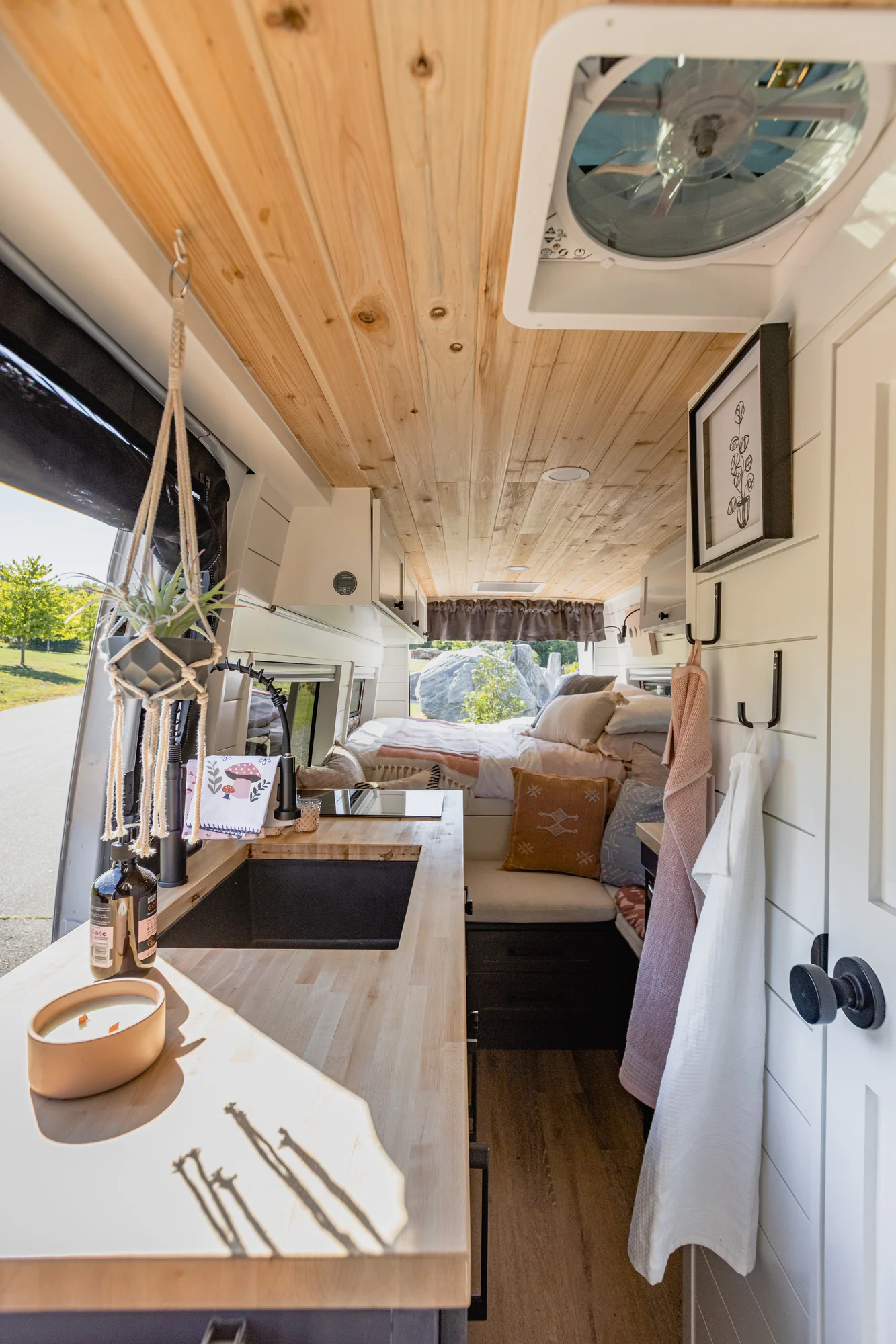 The Drifter 101 custom Mercedes-Benz Sprinter campervan built for Katie by Drifter Vans, with a pink boho interior, butcher block countertop, natural textures, and a full shower