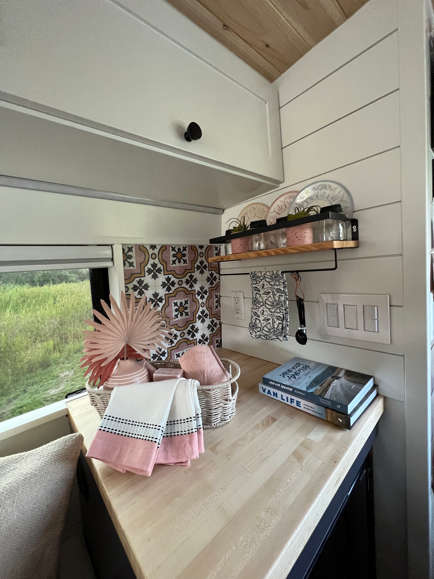 The Drifter 101 custom Mercedes-Benz Sprinter campervan built for Katie by Drifter Vans, with a pink boho interior, butcher block countertop, natural textures, and a full shower