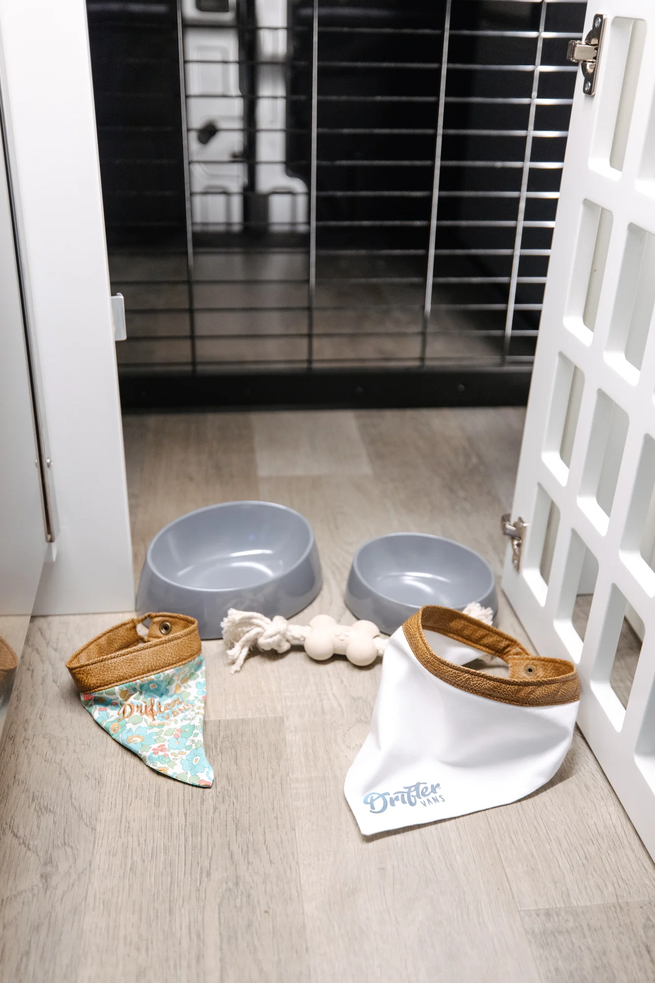 The Drifter 101 custom Ford Transit campervan built for Lisa by Drifter Vans, Wanderer layout with a beachy coastal interior, light blue and white finishes, dog-friendly built-ins, and a swivel chair