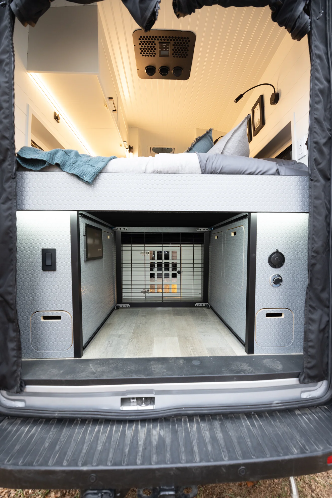 The Drifter 101 custom Ford Transit campervan built for Lisa by Drifter Vans, Wanderer layout with a beachy coastal interior, light blue and white finishes, dog-friendly built-ins, and a swivel chair