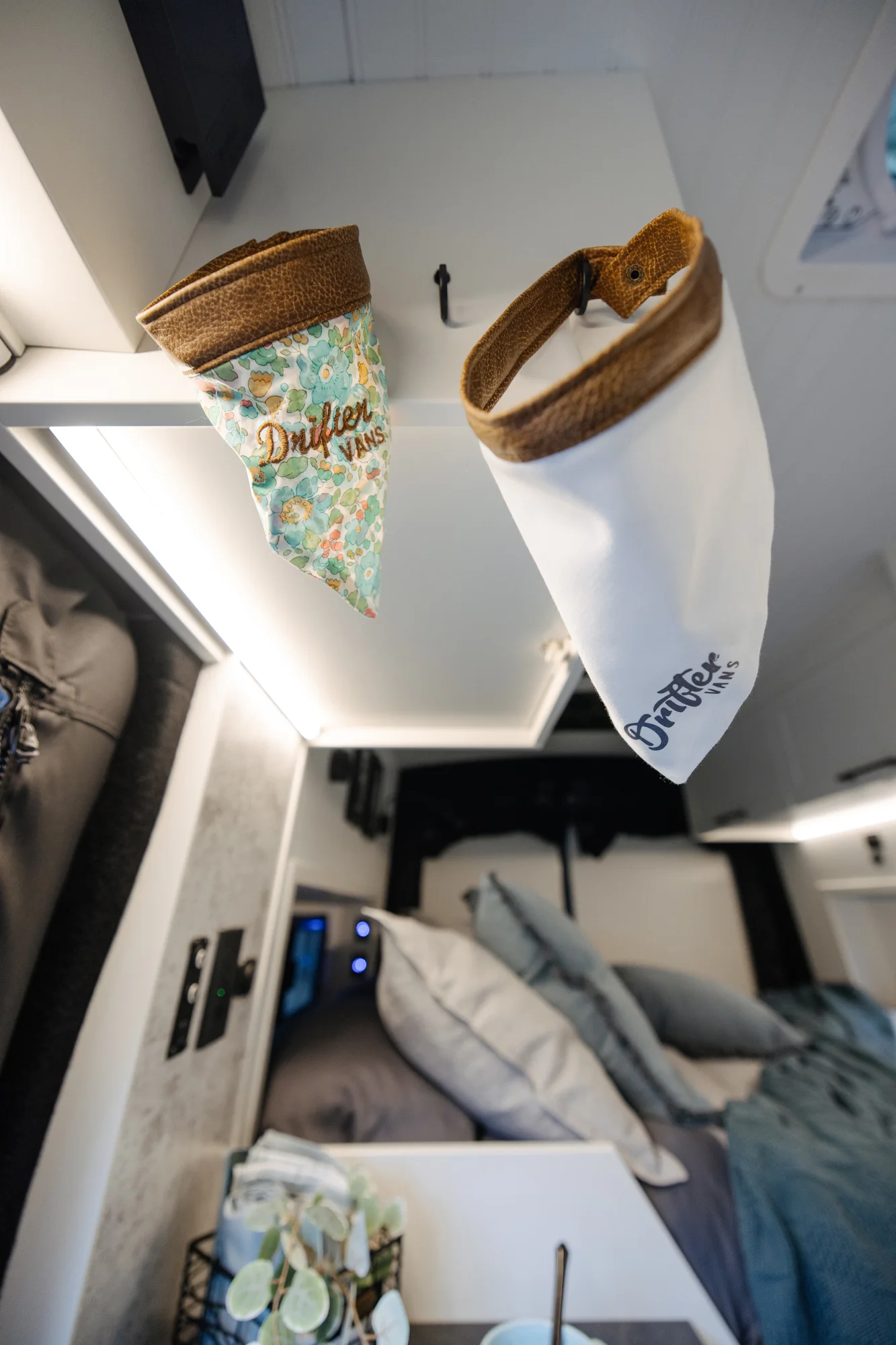 The Drifter 101 custom Ford Transit campervan built for Lisa by Drifter Vans, Wanderer layout with a beachy coastal interior, light blue and white finishes, dog-friendly built-ins, and a swivel chair