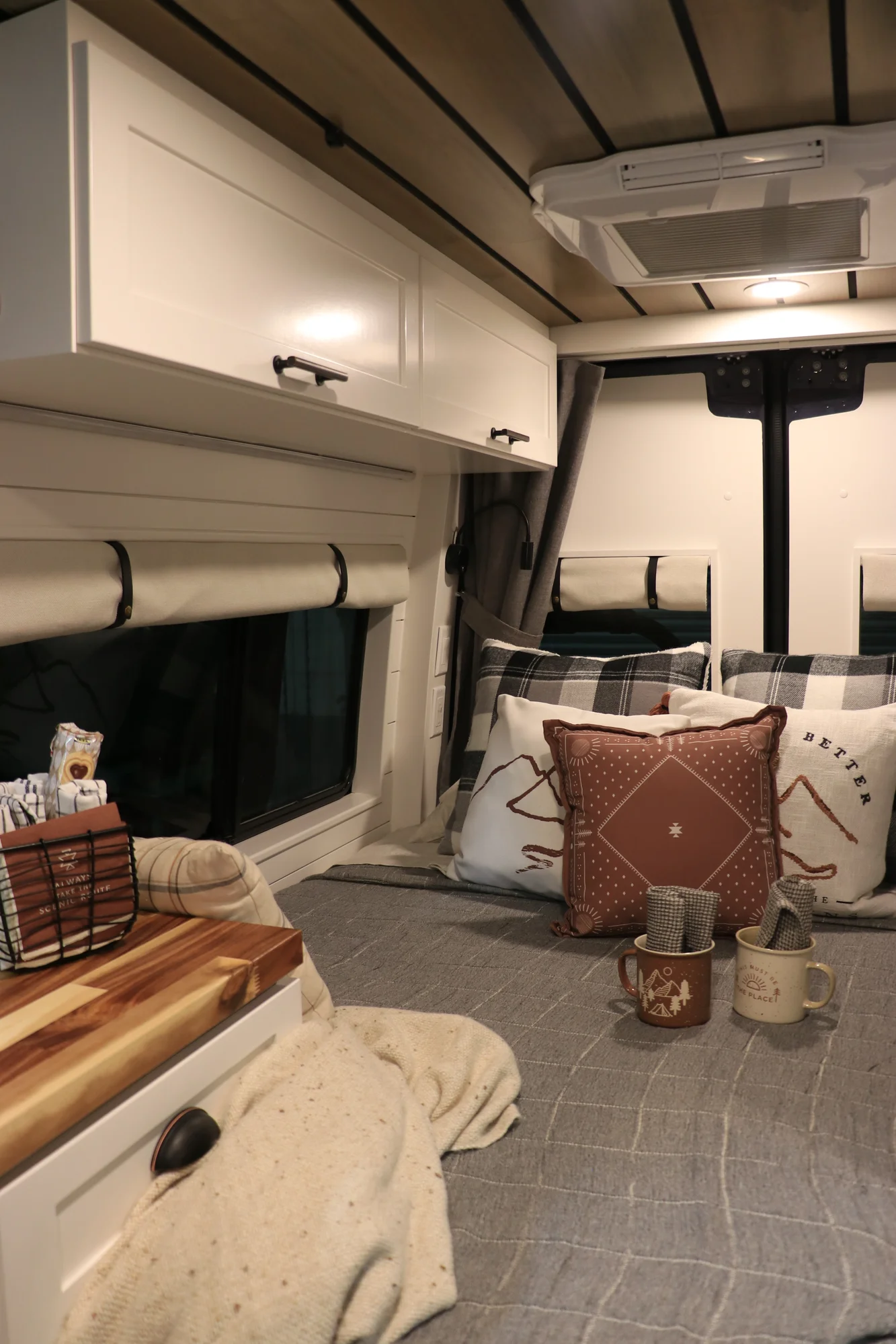 The Drifter 101 custom Mercedes-Benz Sprinter campervan built for Dave by Drifter Vans, with a wood plank ceiling, butcher block countertop, black faucet, and stainless appliances