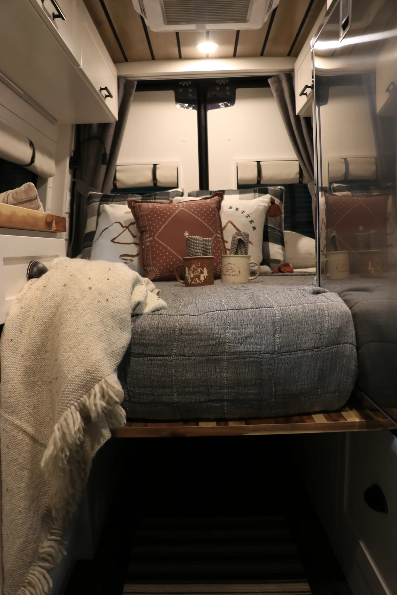 The Drifter 101 custom Mercedes-Benz Sprinter campervan built for Dave by Drifter Vans, with a wood plank ceiling, butcher block countertop, black faucet, and stainless appliances