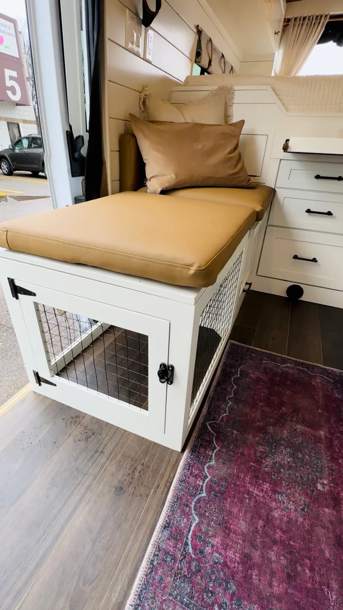 The Drifter 101 custom Ford Transit campervan built for Valerie by Drifter Vans, with a rose boho interior, copper sink, earthy wood tones, and a built-in dog crate
