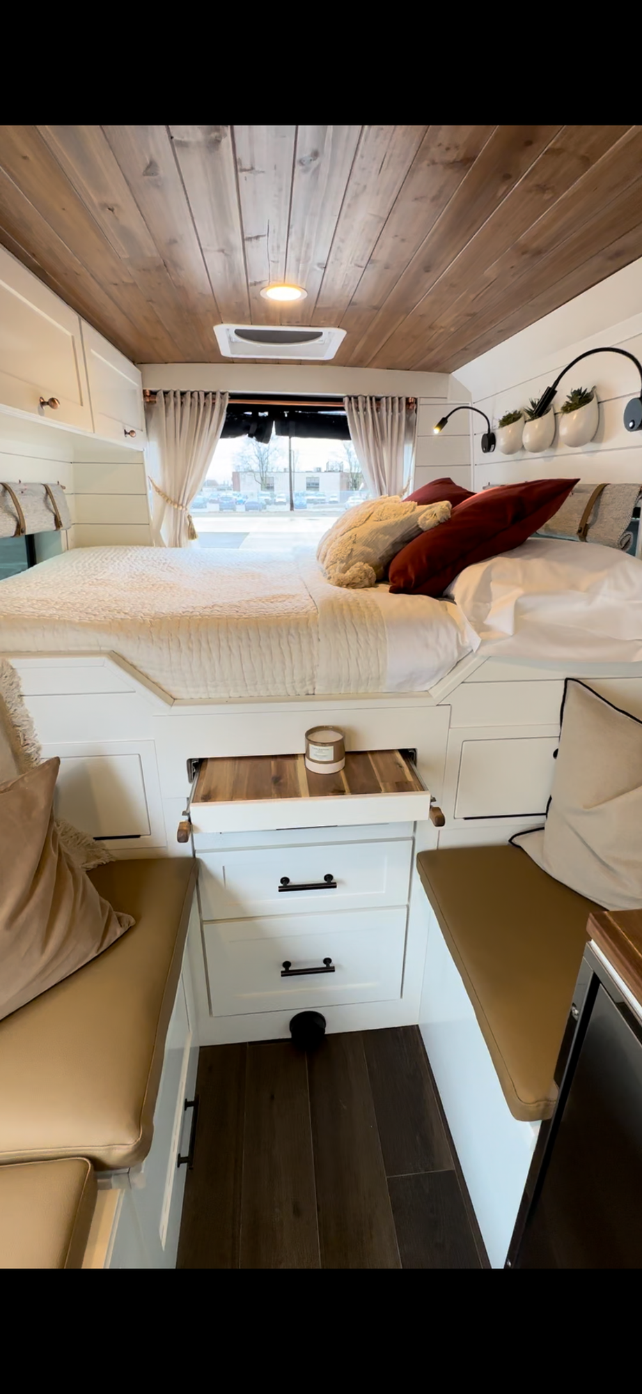 The Drifter 101 custom Ford Transit campervan built for Valerie by Drifter Vans, with a rose boho interior, copper sink, earthy wood tones, and a built-in dog crate