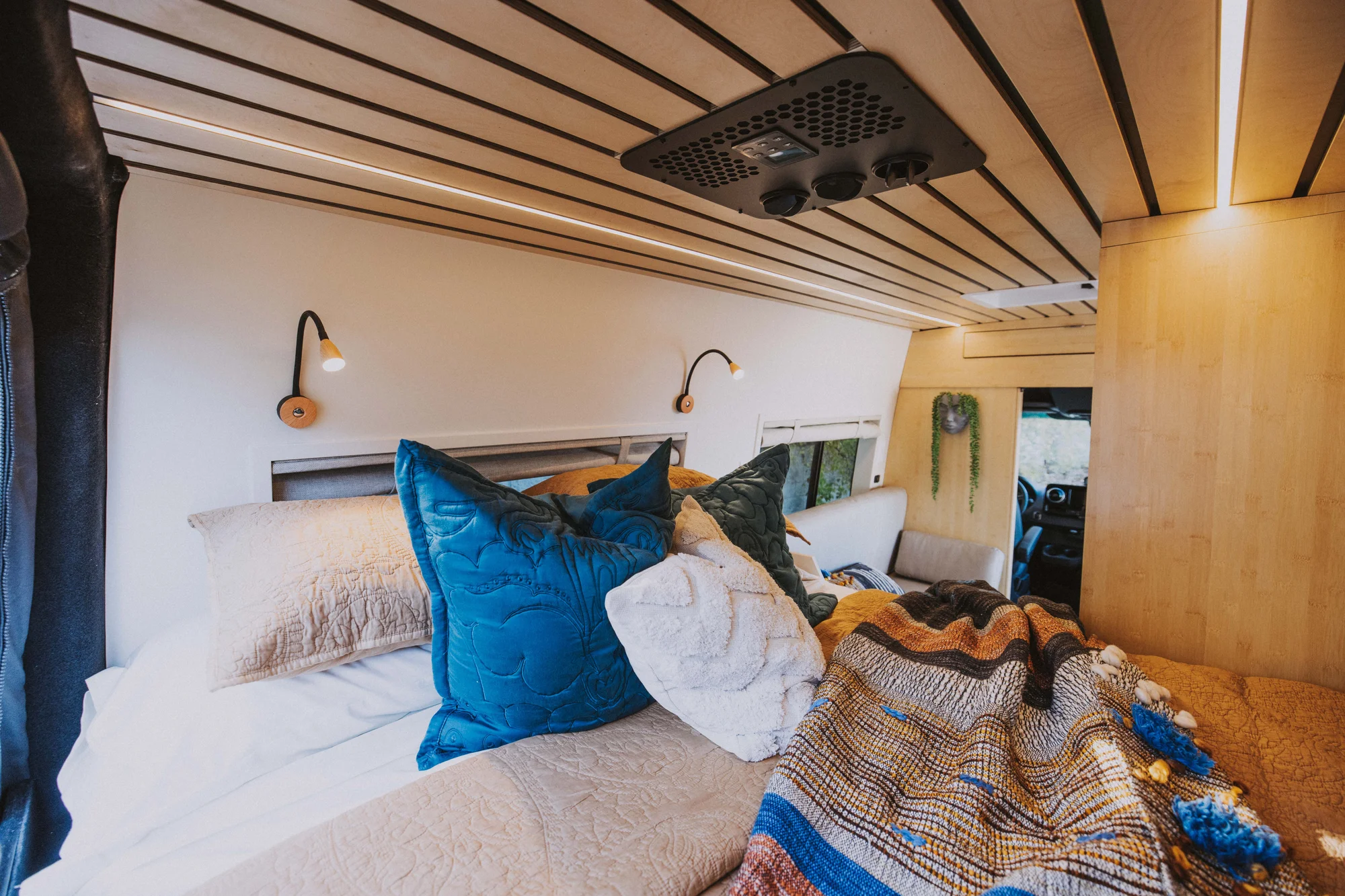 The Drifter 101 custom Mercedes-Benz Sprinter campervan built for Rosa by Drifter Vans, with a natural bamboo interior, built-in dog bowls, and a full bed platform