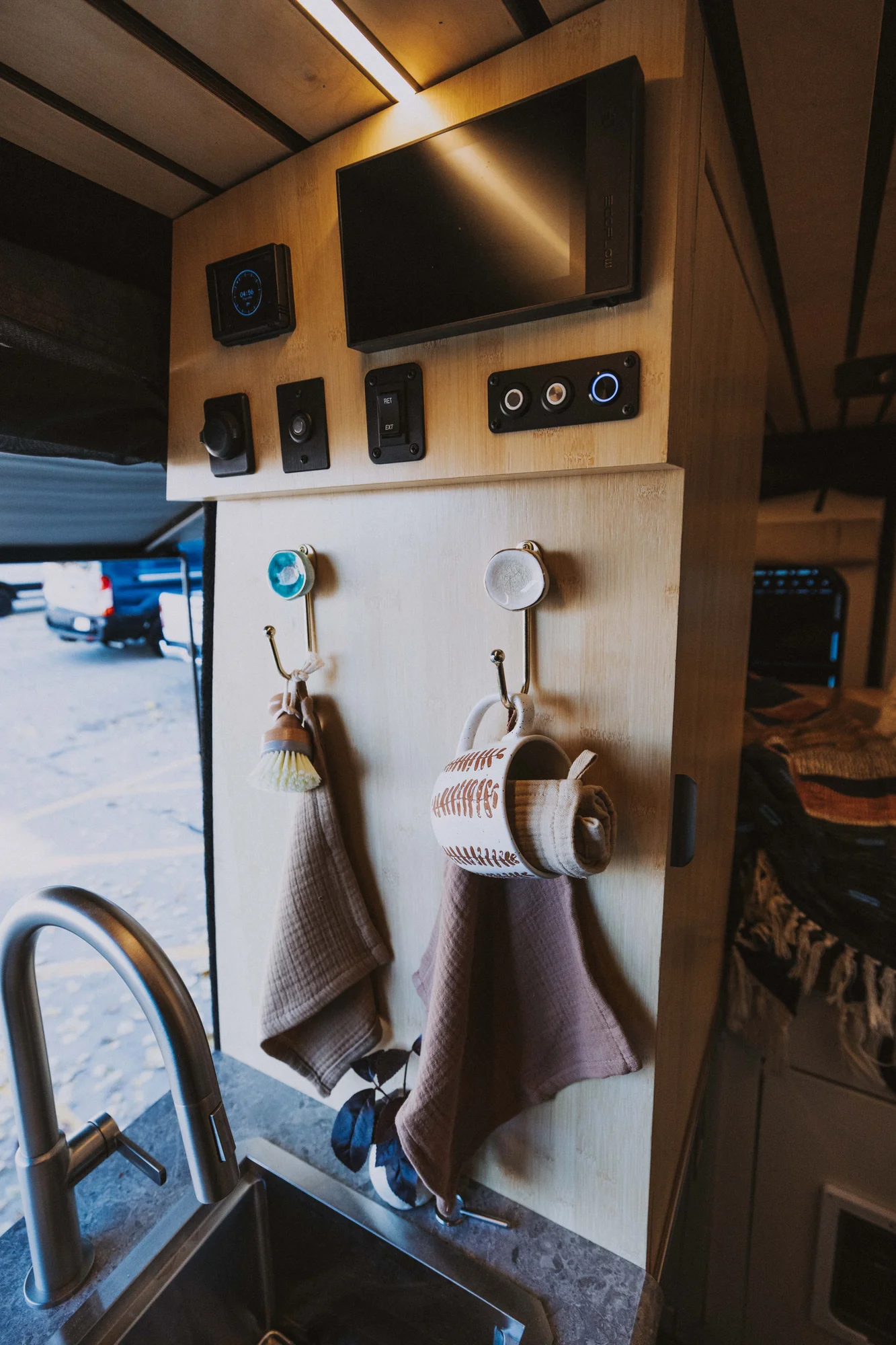 The Drifter 101 custom Mercedes-Benz Sprinter campervan built for Rosa by Drifter Vans, with a natural bamboo interior, built-in dog bowls, and a full bed platform