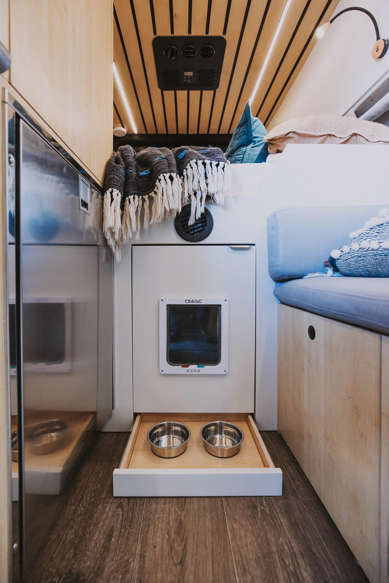 The Drifter 101 custom Mercedes-Benz Sprinter campervan built for Rosa by Drifter Vans, with a natural bamboo interior, built-in dog bowls, and a full bed platform