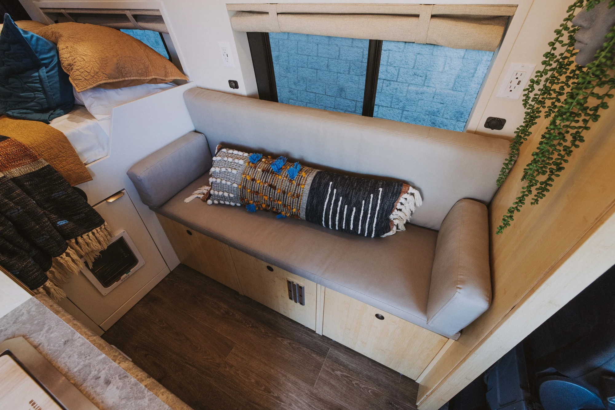 The Drifter 101 custom Mercedes-Benz Sprinter campervan built for Rosa by Drifter Vans, with a natural bamboo interior, built-in dog bowls, and a full bed platform